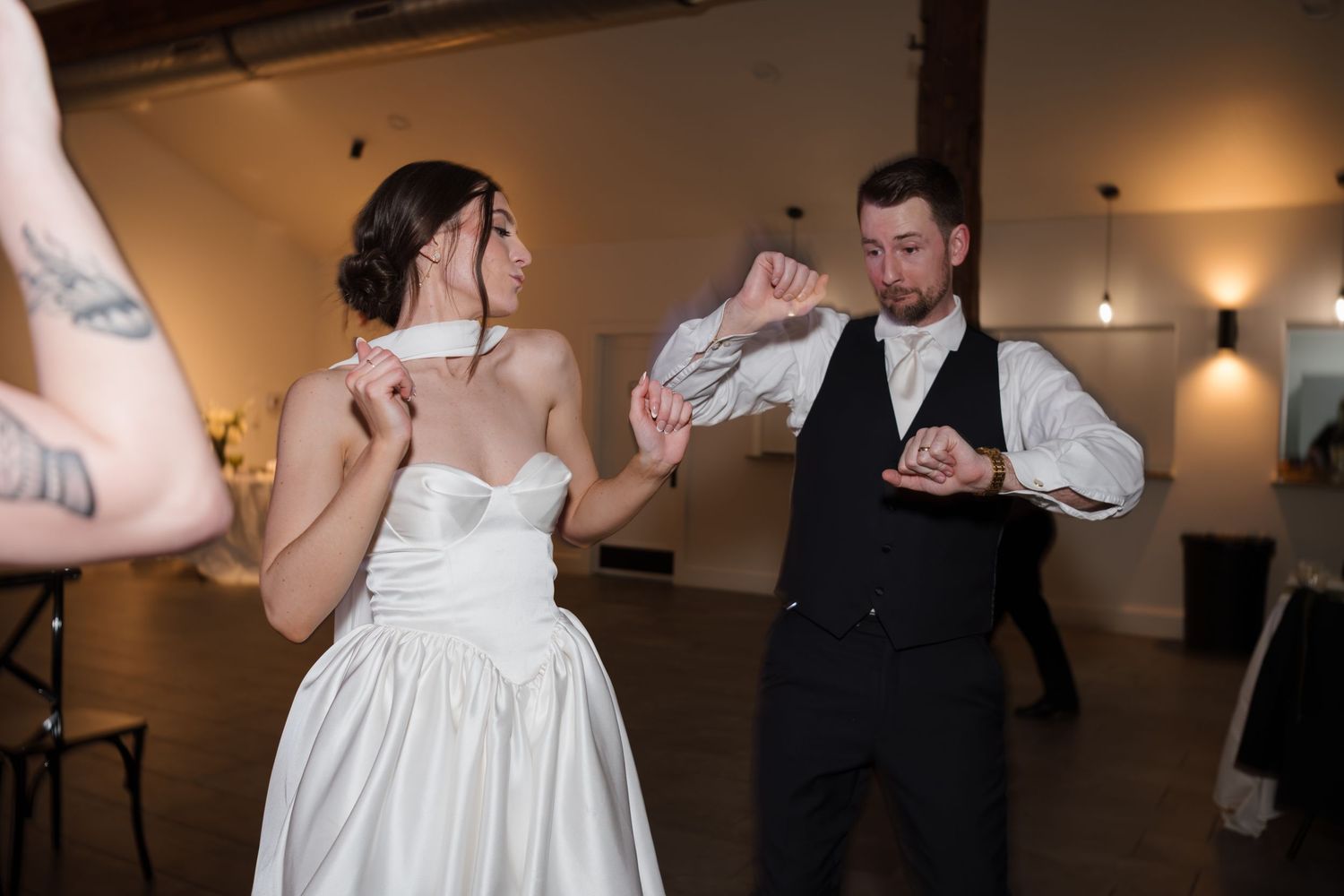 Wedding reception dance floor moments showing couples dancing and celebrating in an indoor venue.