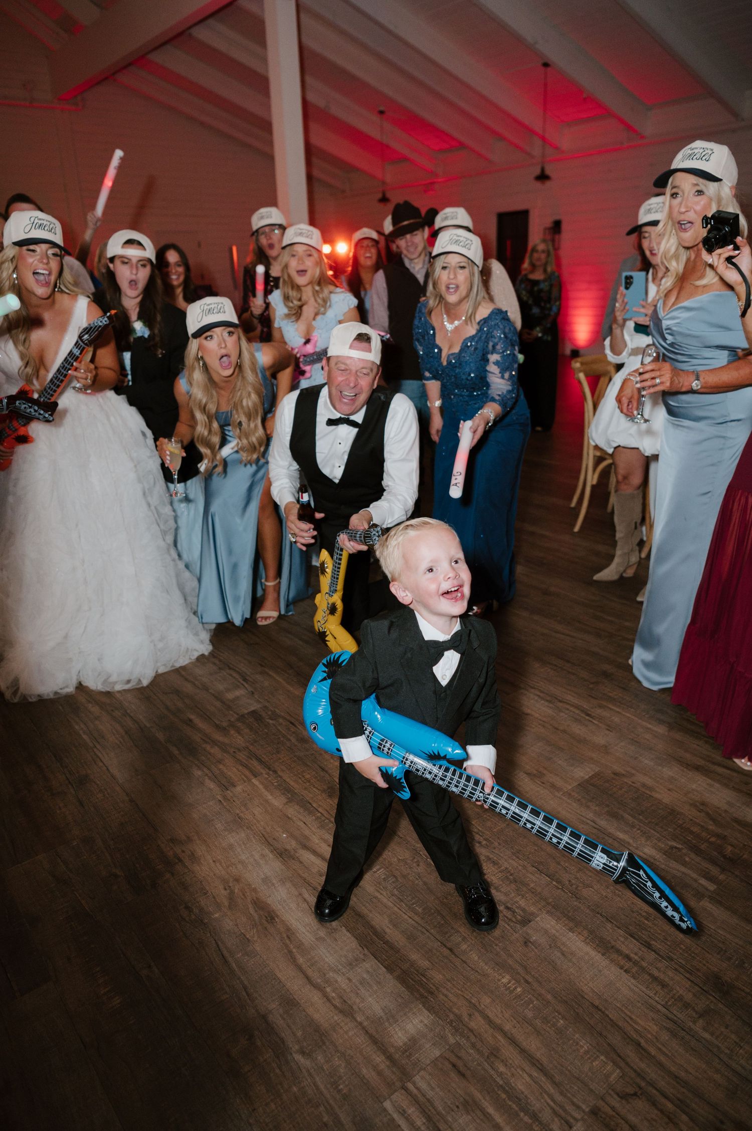 A group of people dressed in costumes and holding instruments at a wedding reception.