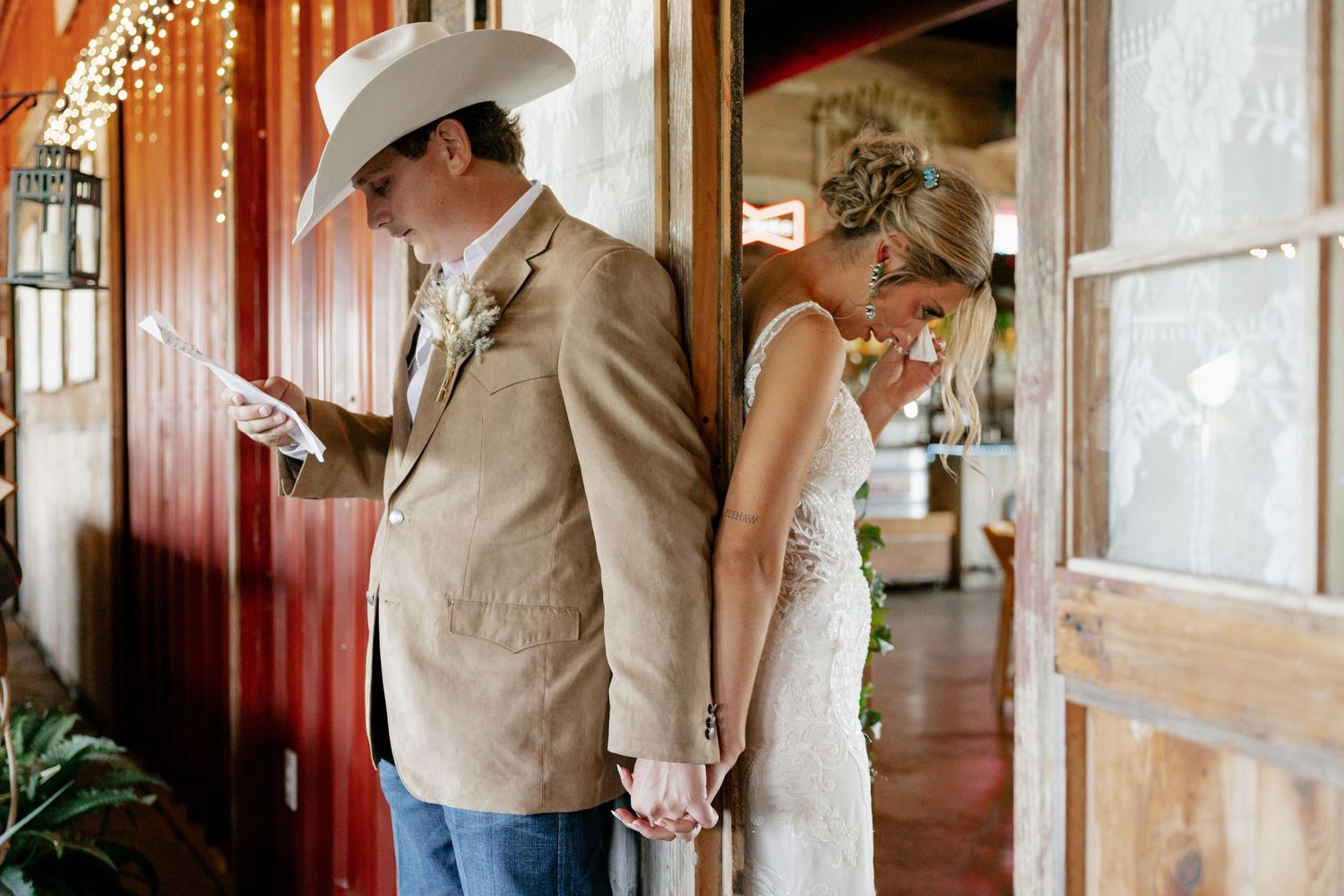 A couple shares a private moment before their rustic barn wedding ceremony.