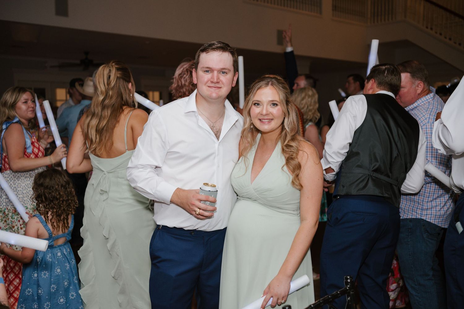 Party guests enjoying themselves at an evening wedding reception.