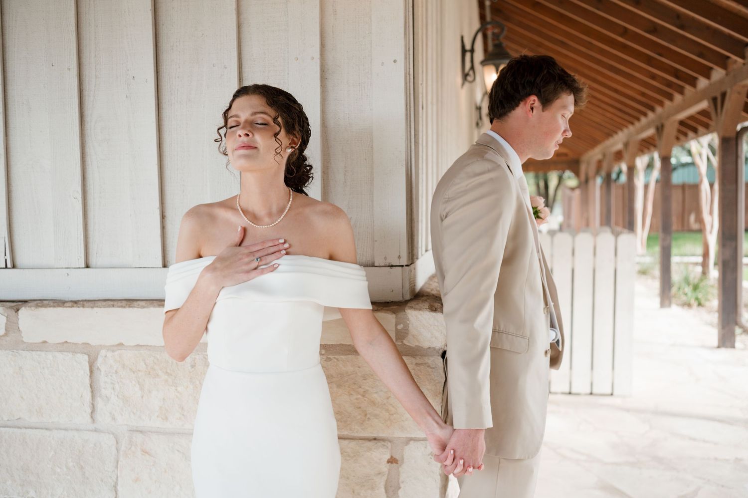 A bride and groom share an intimate moment during their wedding celebration in a rustic wooden venue.