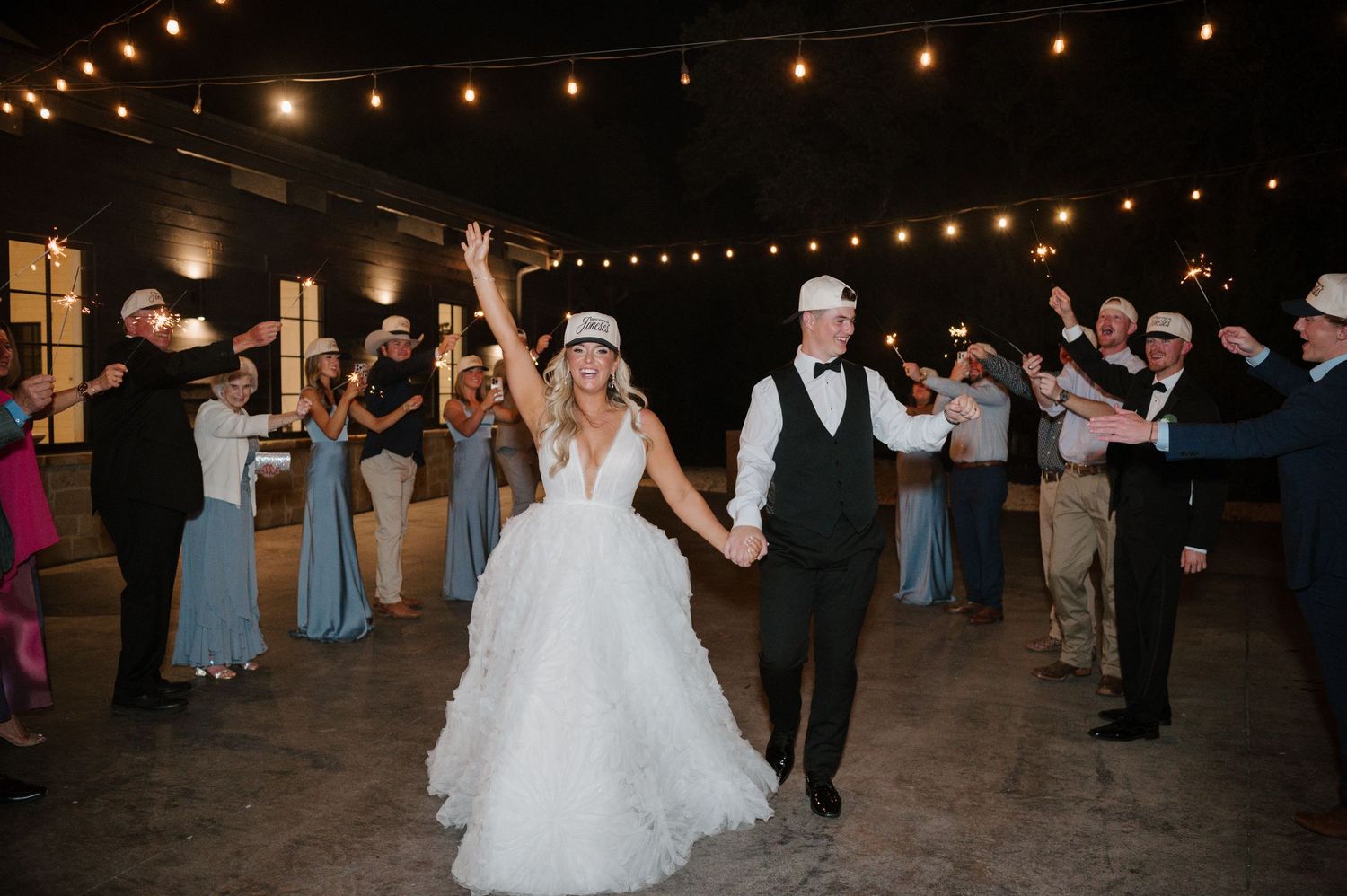 A bride and groom walking together on the dance floor at their wedding reception.