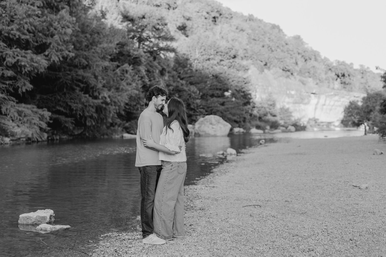 A series of black and white photographs showing people fishing along a riverbank in a scenic landscape setting.