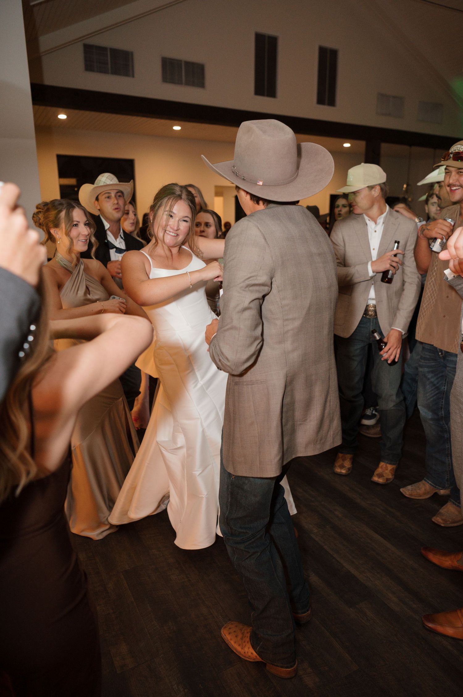 A bride & groom dance with their guests at a Texas wedding in the Texas Hill Country photographed by Alyssa Denson Photography.