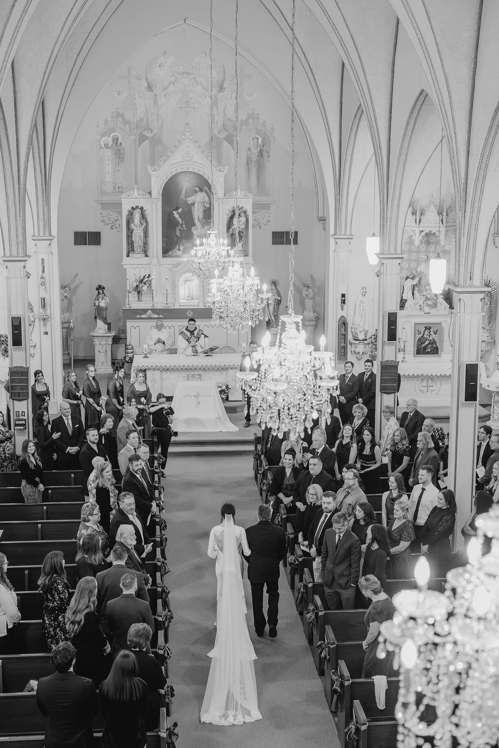 A bride & her dad walk down the aisle in a catholic church in Saint Hedwig, Texas photographed by Alyssa Denson Photography.