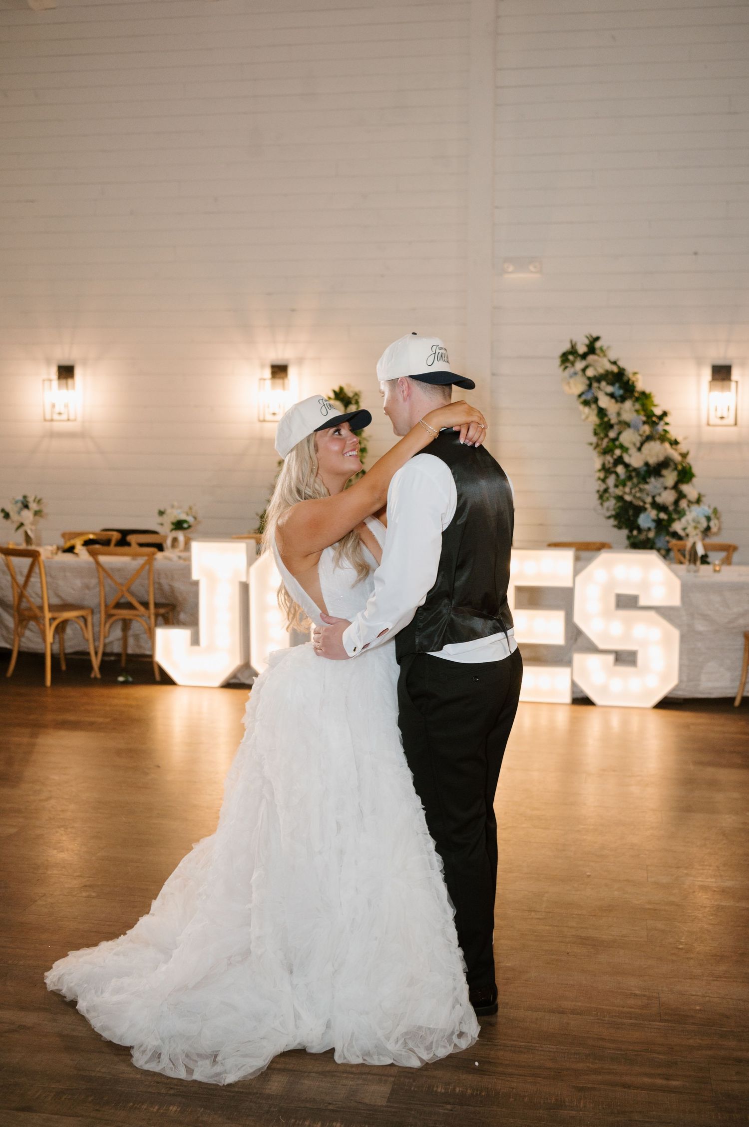 A bride and groom dancing together on the dance floor at their wedding reception.