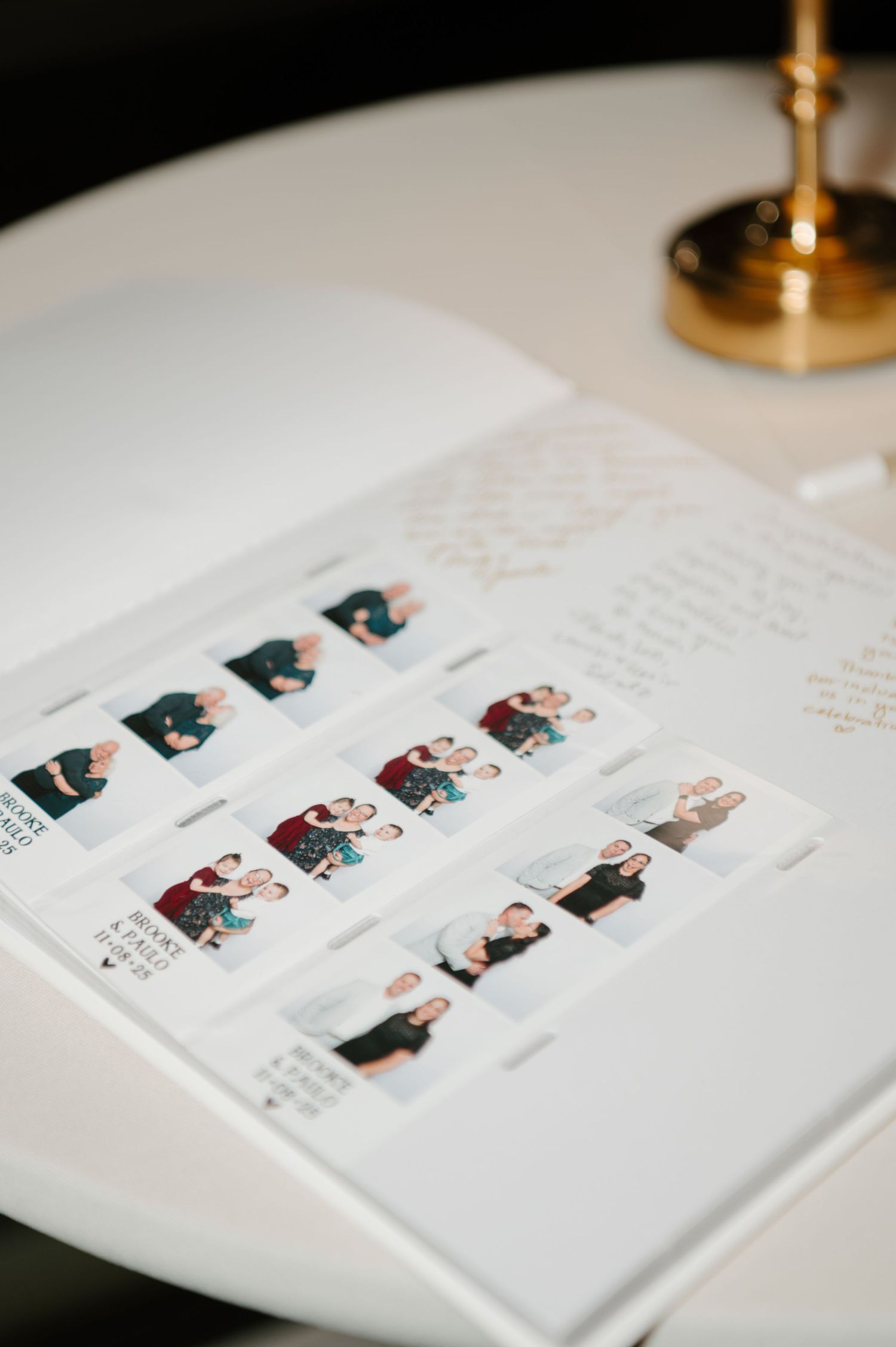 Wedding photo album pages laid out on white surface with gold accents.