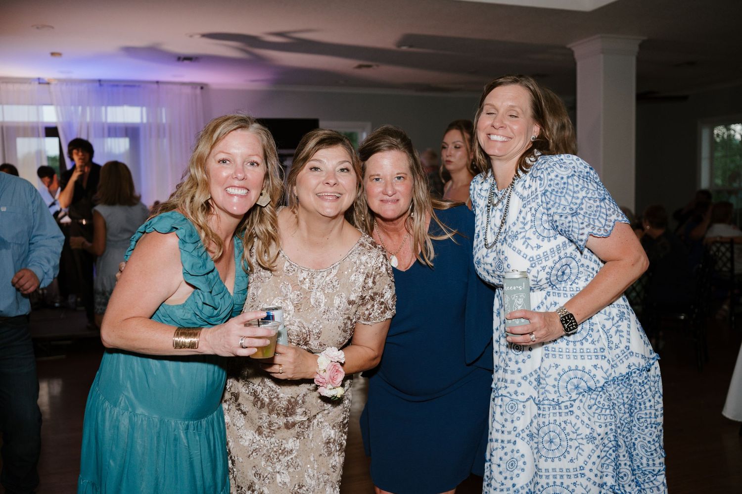 Wedding reception guests enjoying the celebration in evening formal attire.