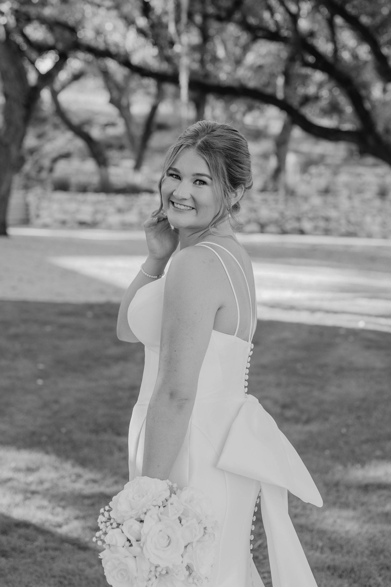 A stunning bridal portrait series in black and white showing joyful moments and elegant dress details.