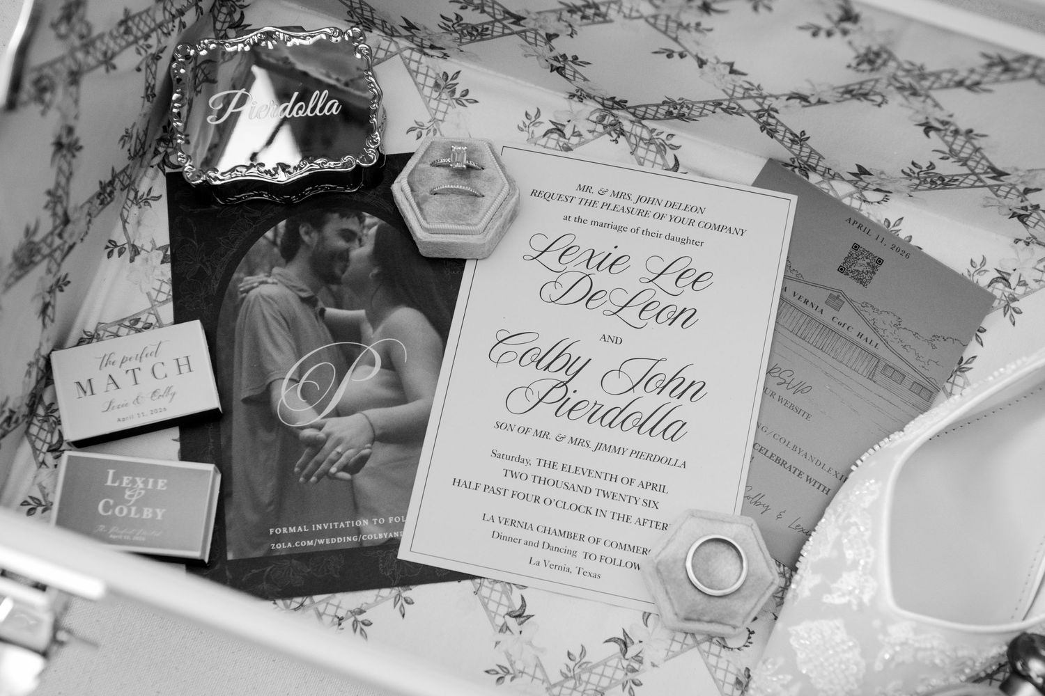 Black and white wedding invitation suite for Lexie Lee De Leon and Colby John Frodella displayed elegantly.