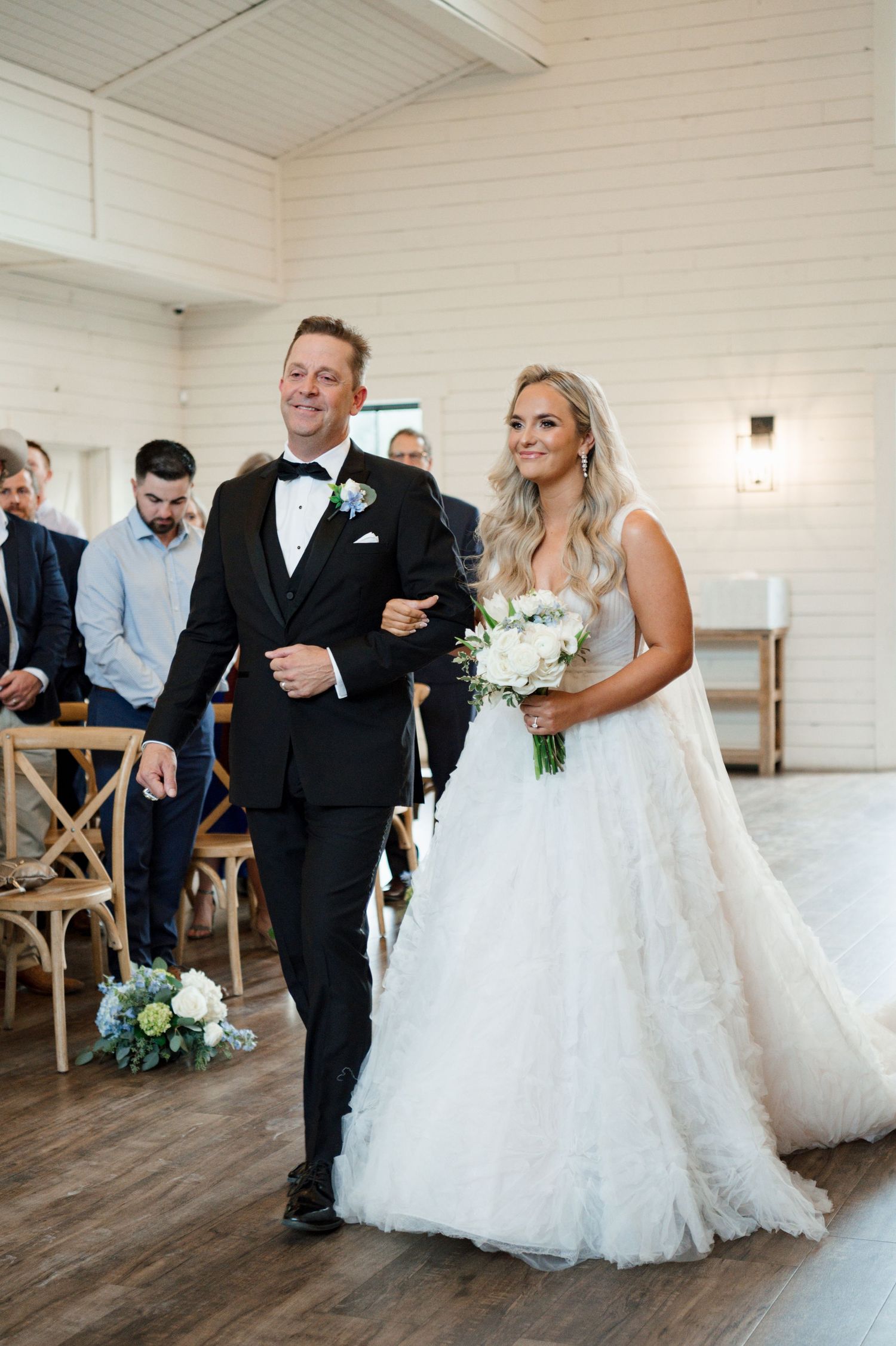A bride and groom walking down the aisle together at their wedding ceremony.