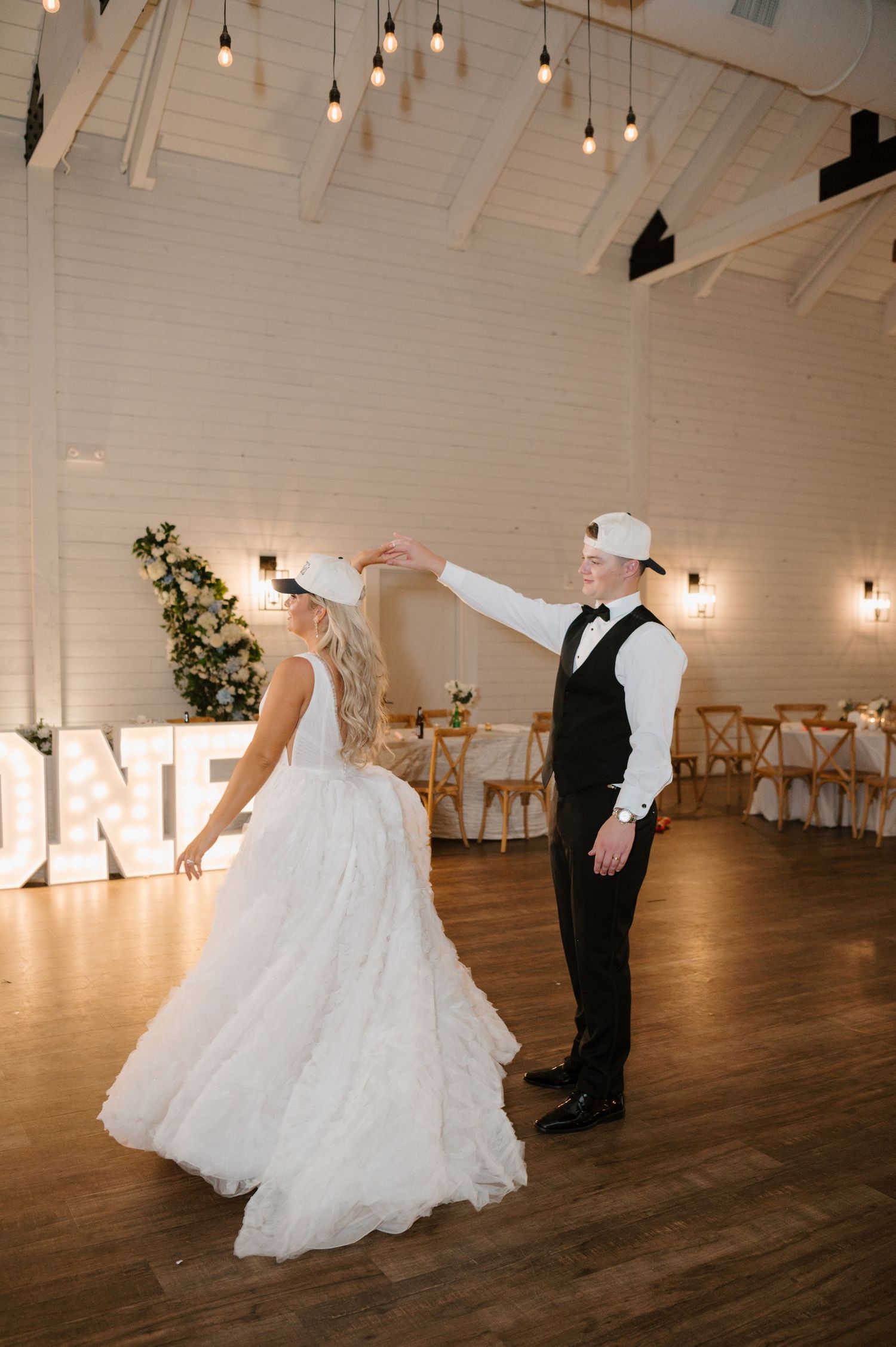 A bride and groom dancing together on the dance floor at their wedding reception.