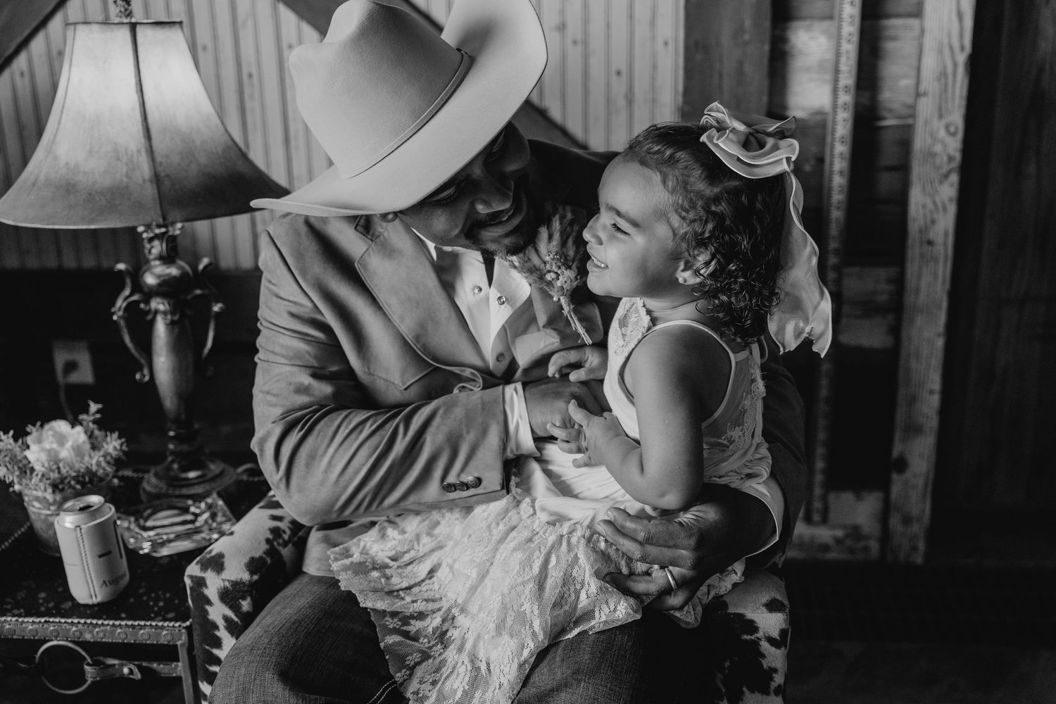 Vintage black and white photograph of tender moment in rustic setting.