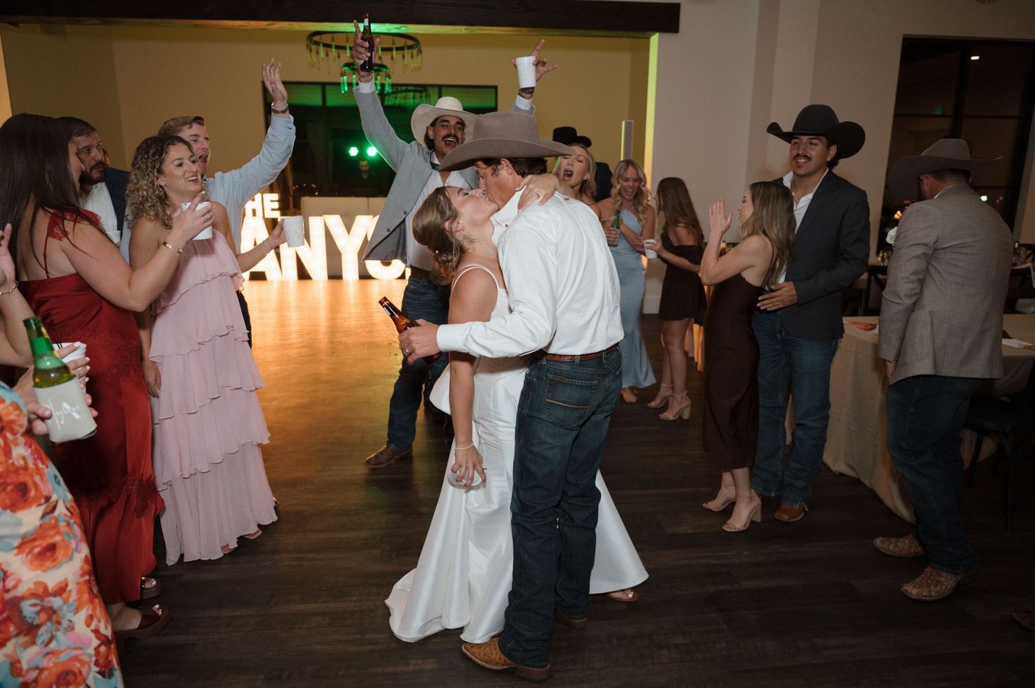 A bride & groom dance with their guests at their wedding reception at Hidden Falls Hayes Hollow in Spring Branch, TX.
