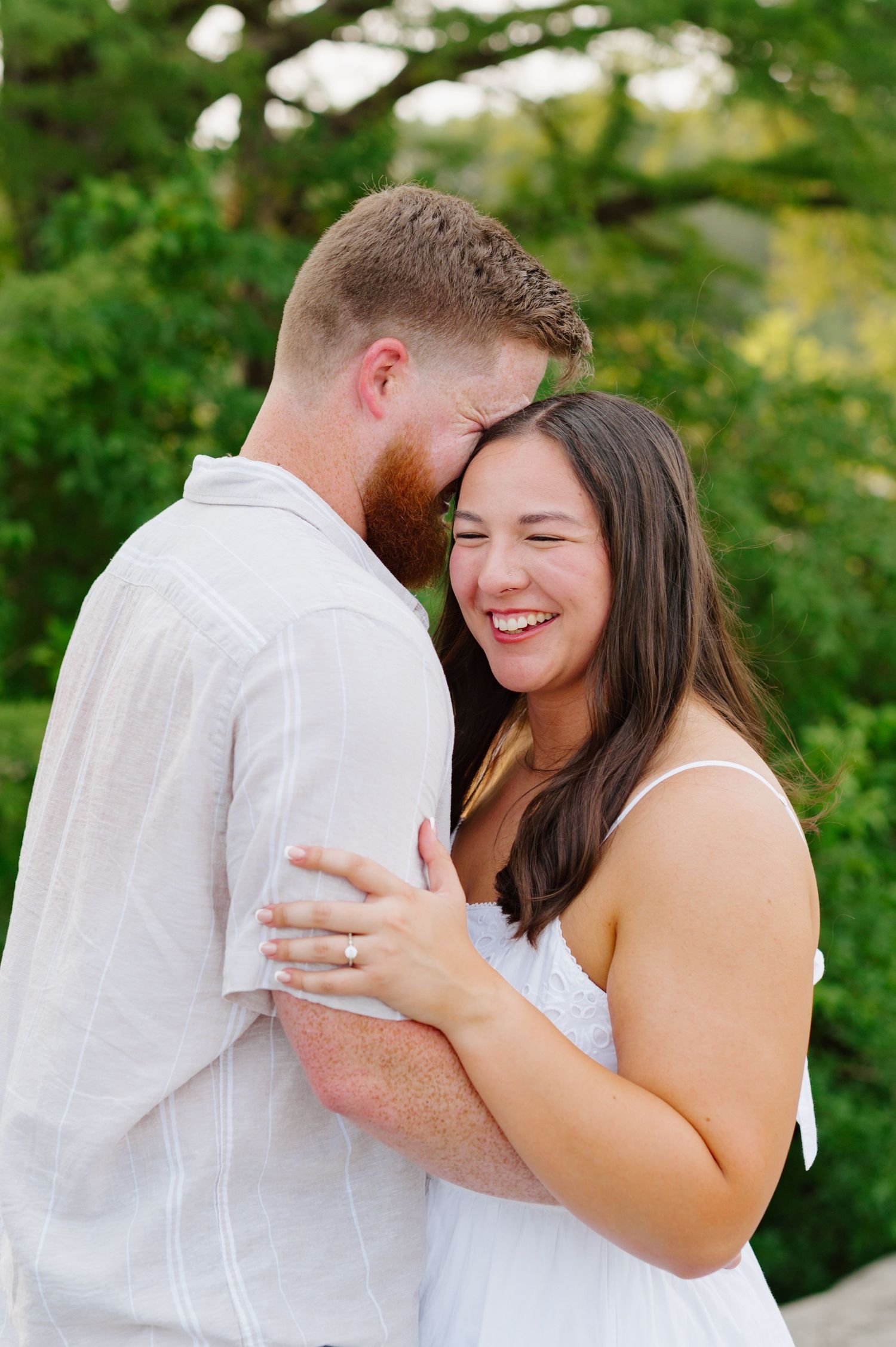 A romantic engagement photoshoot sequence showing a couple embracing joyfully in a lush green outdoor setting.