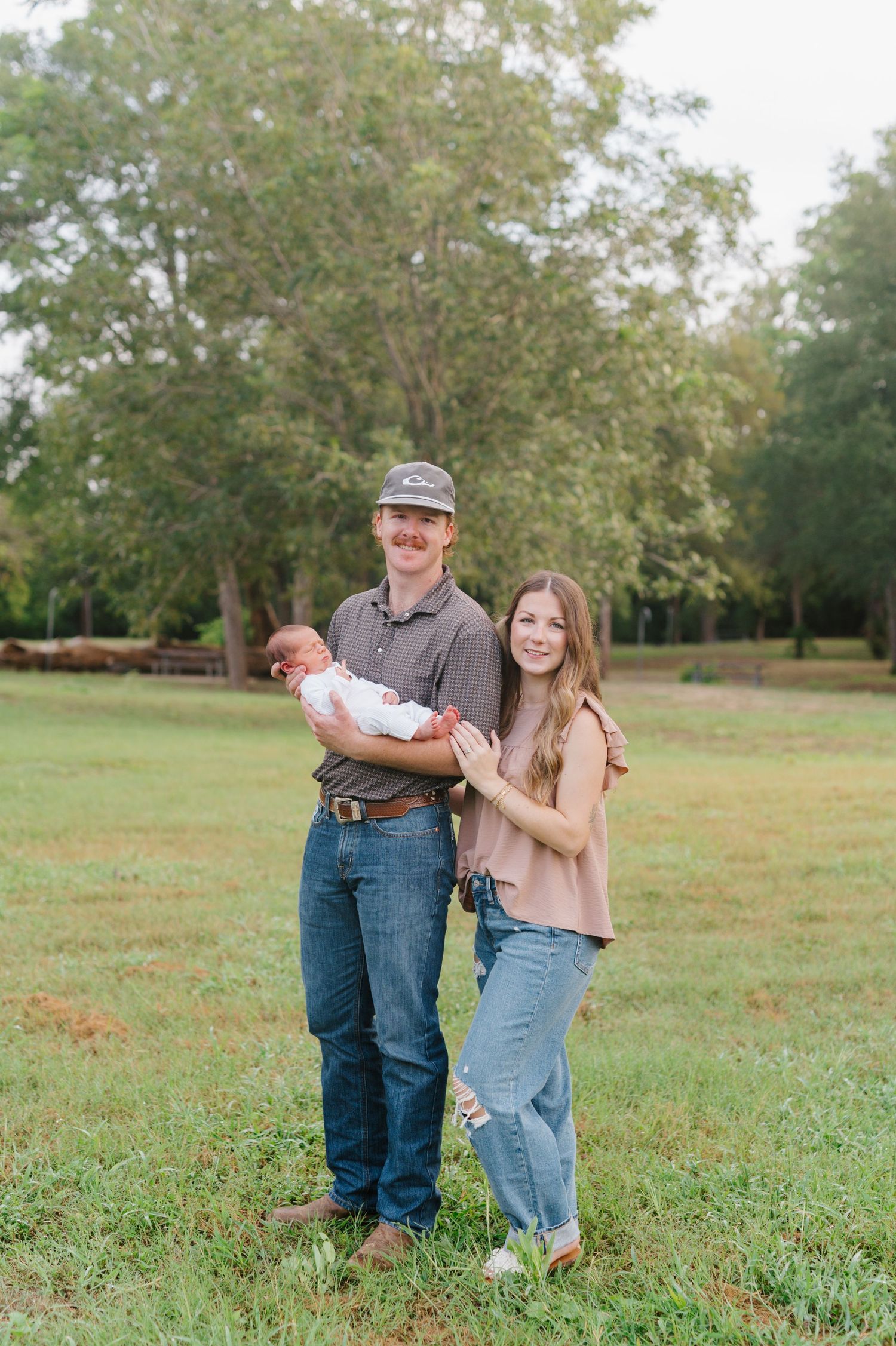 A scenic outdoor photoshoot sequence in a grassy field with trees in the background.