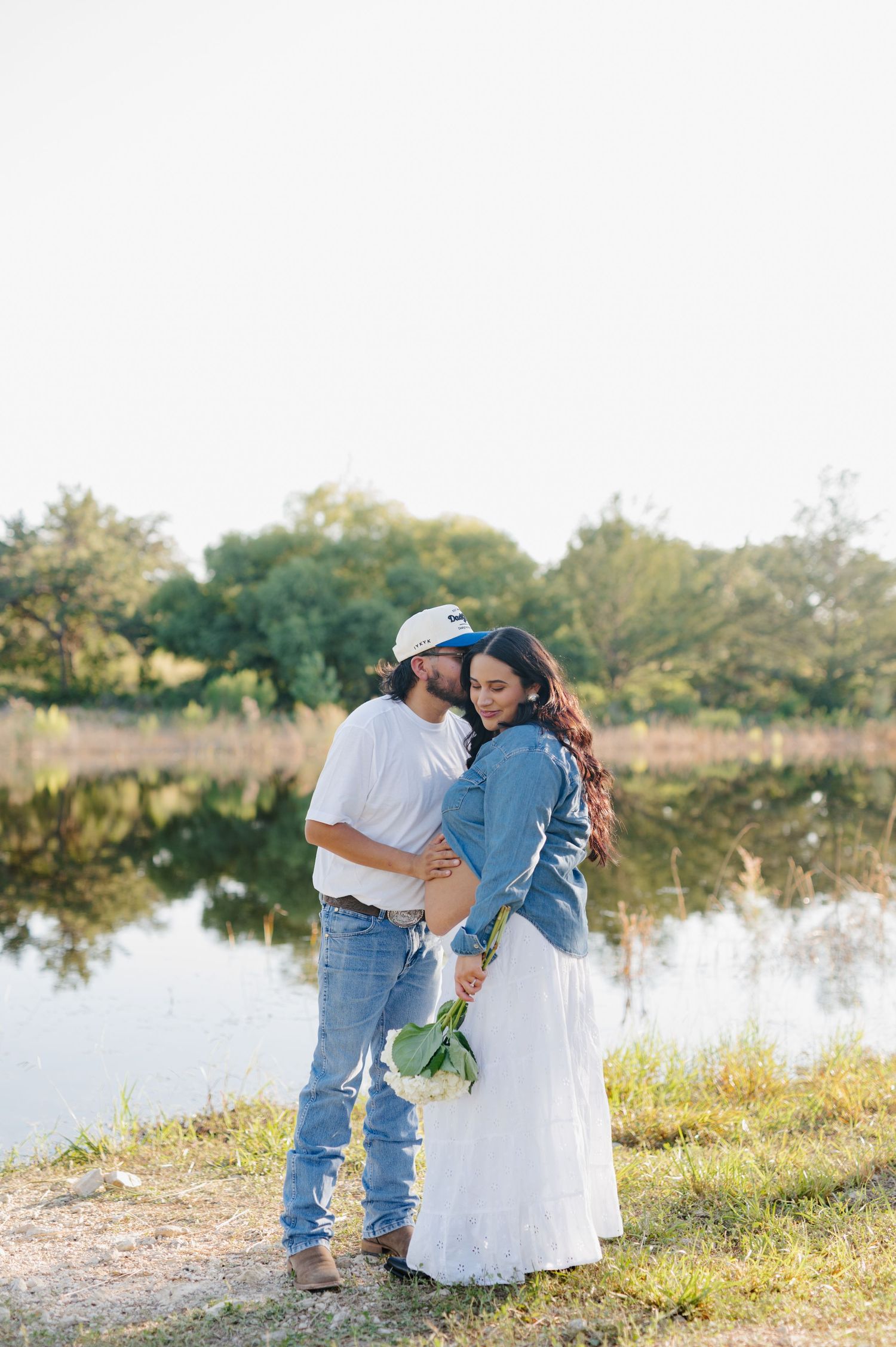 A romantic waterfront photoshoot with natural scenery in the background.