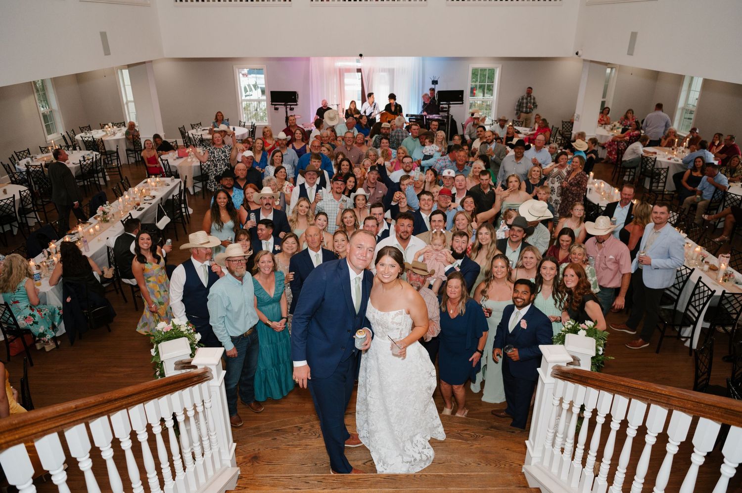 Wide view of wedding ceremony in a traditional church filled with guests.