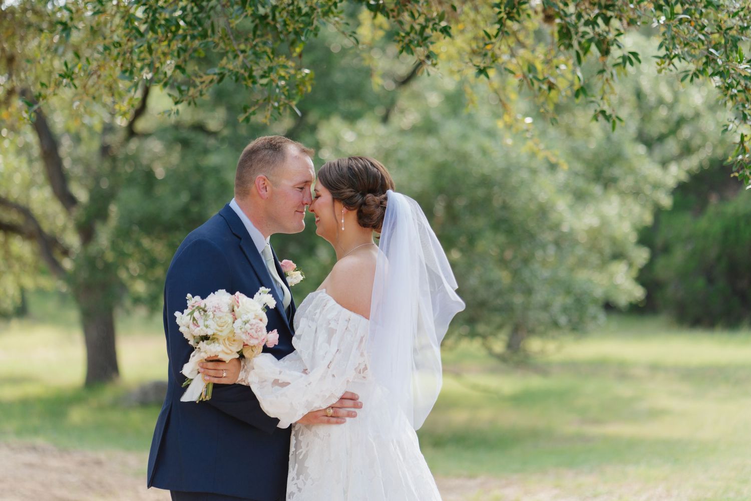 Romantic wedding portrait session in a sunlit garden setting.