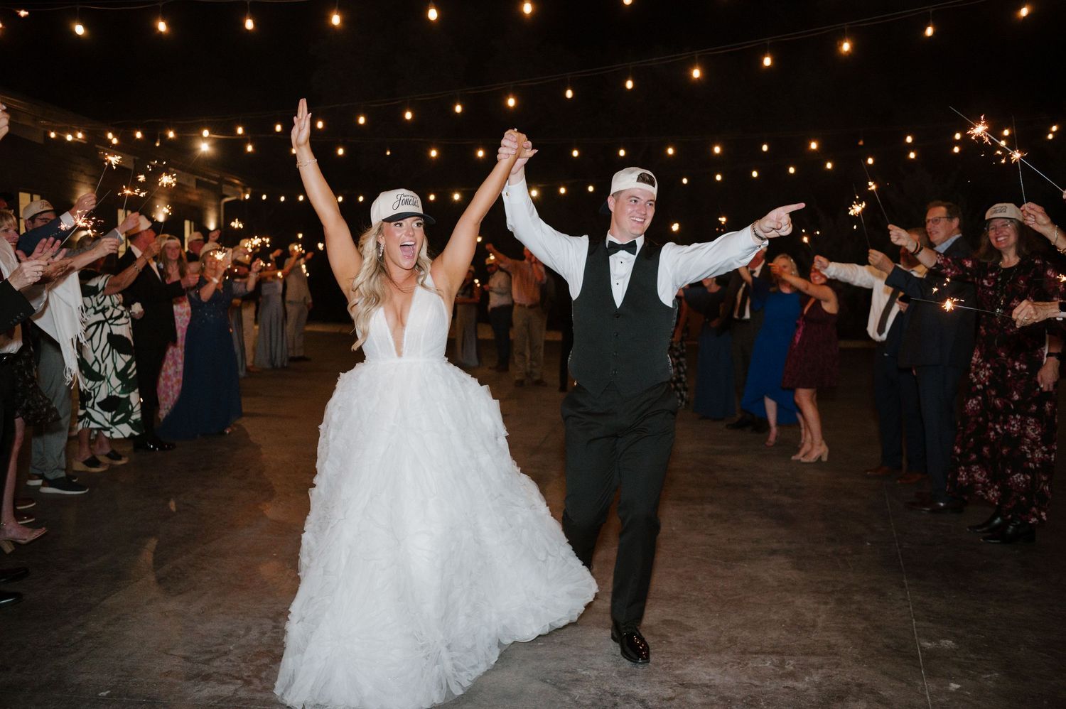 A bride and groom dancing together on the dance floor at their wedding reception, surrounded by guests.