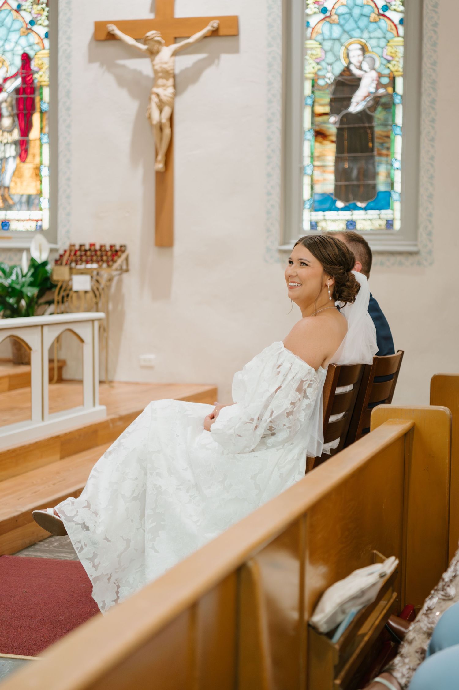 A serene moment in a church with stained glass windows and wooden pews.