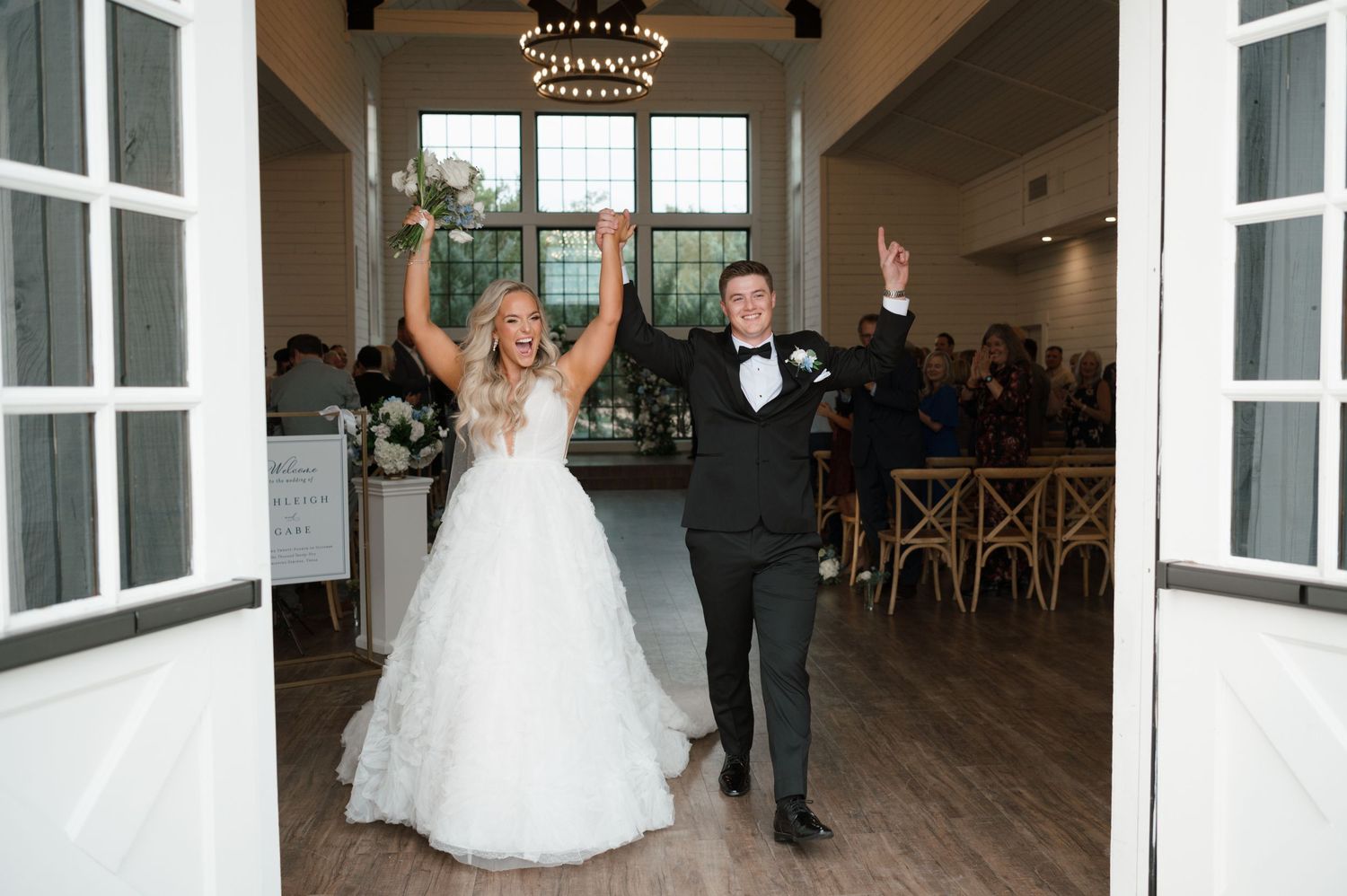 A bride & groom celebrate as they exit their wedding ceremony in the Texas hill country photographed by Alyssa Denson Photography.