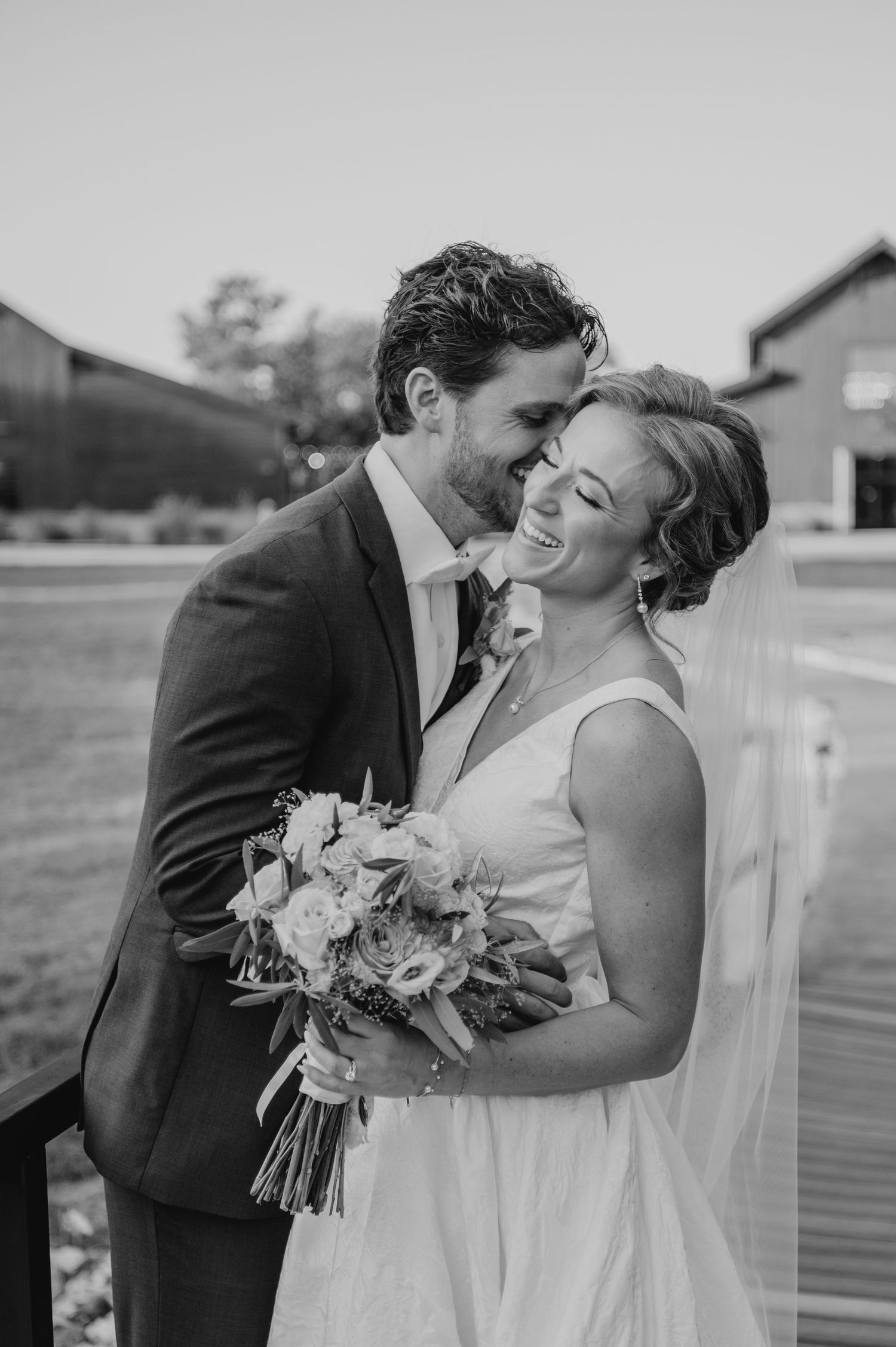 A romantic black and white wedding photo series showing tender moments between newlyweds on their special day.