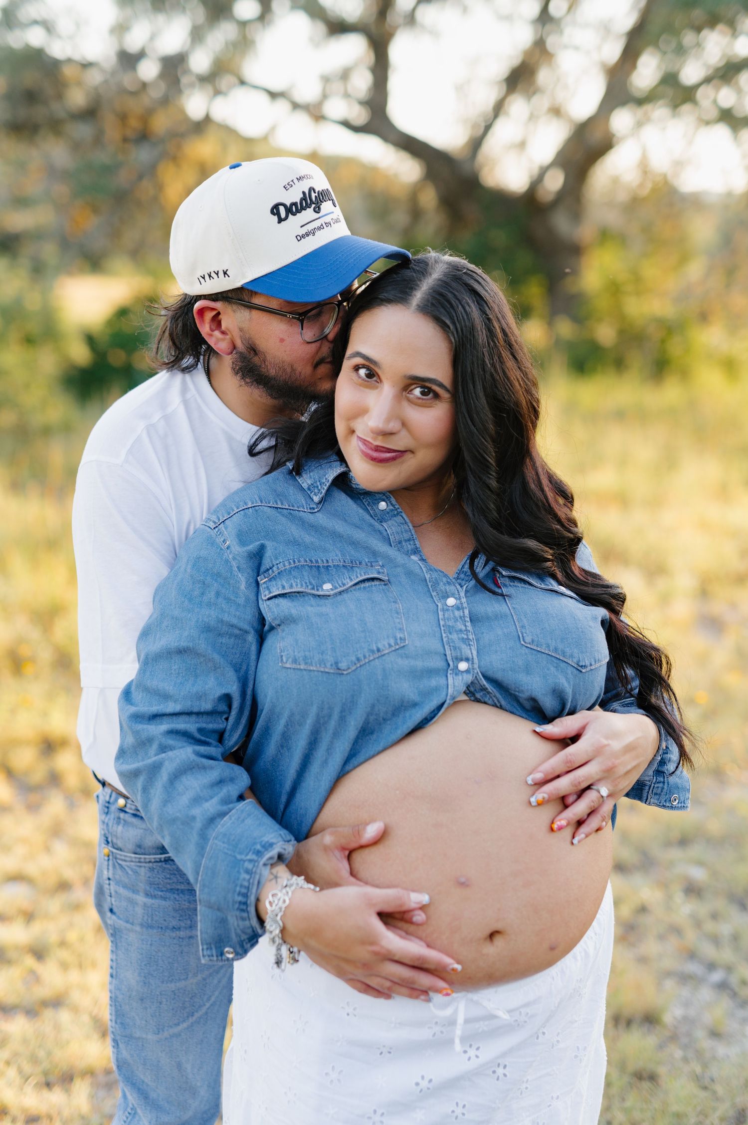 A maternity photography session showing intimate moments with a baby bump in an outdoor setting.