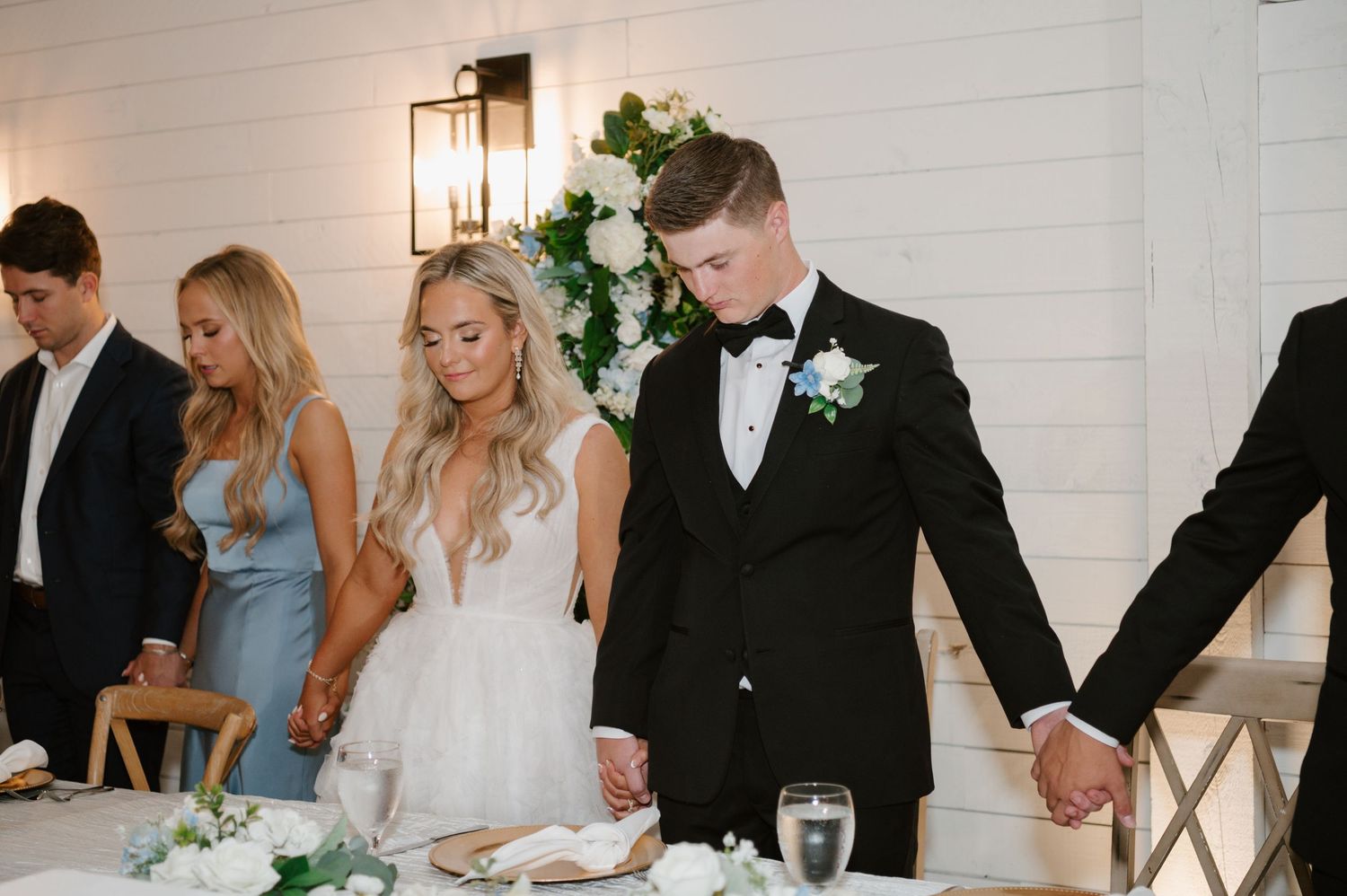 A bride and groom cutting their wedding cake together at their reception.