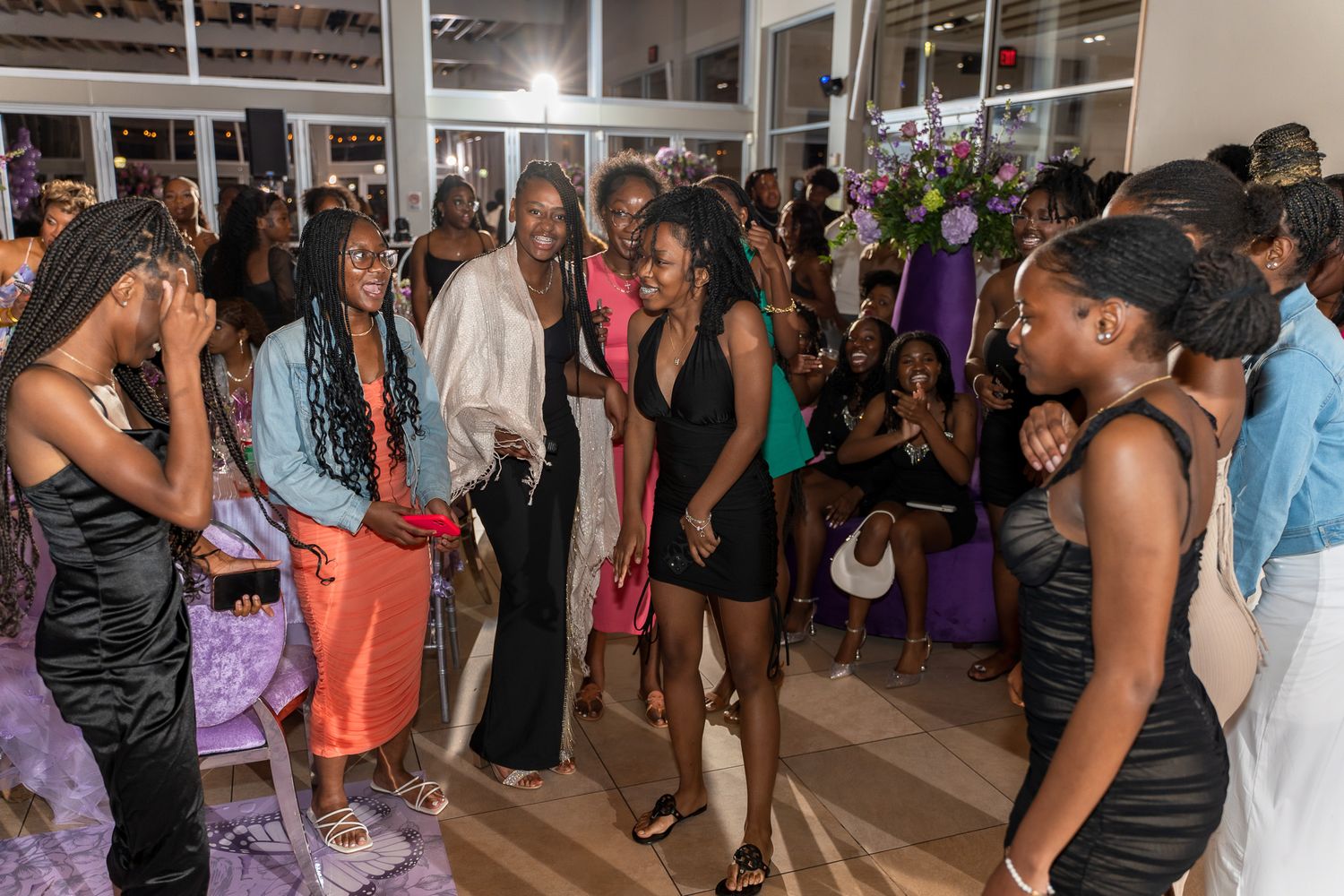 Party guests mingle and socialize at an indoor celebration event.