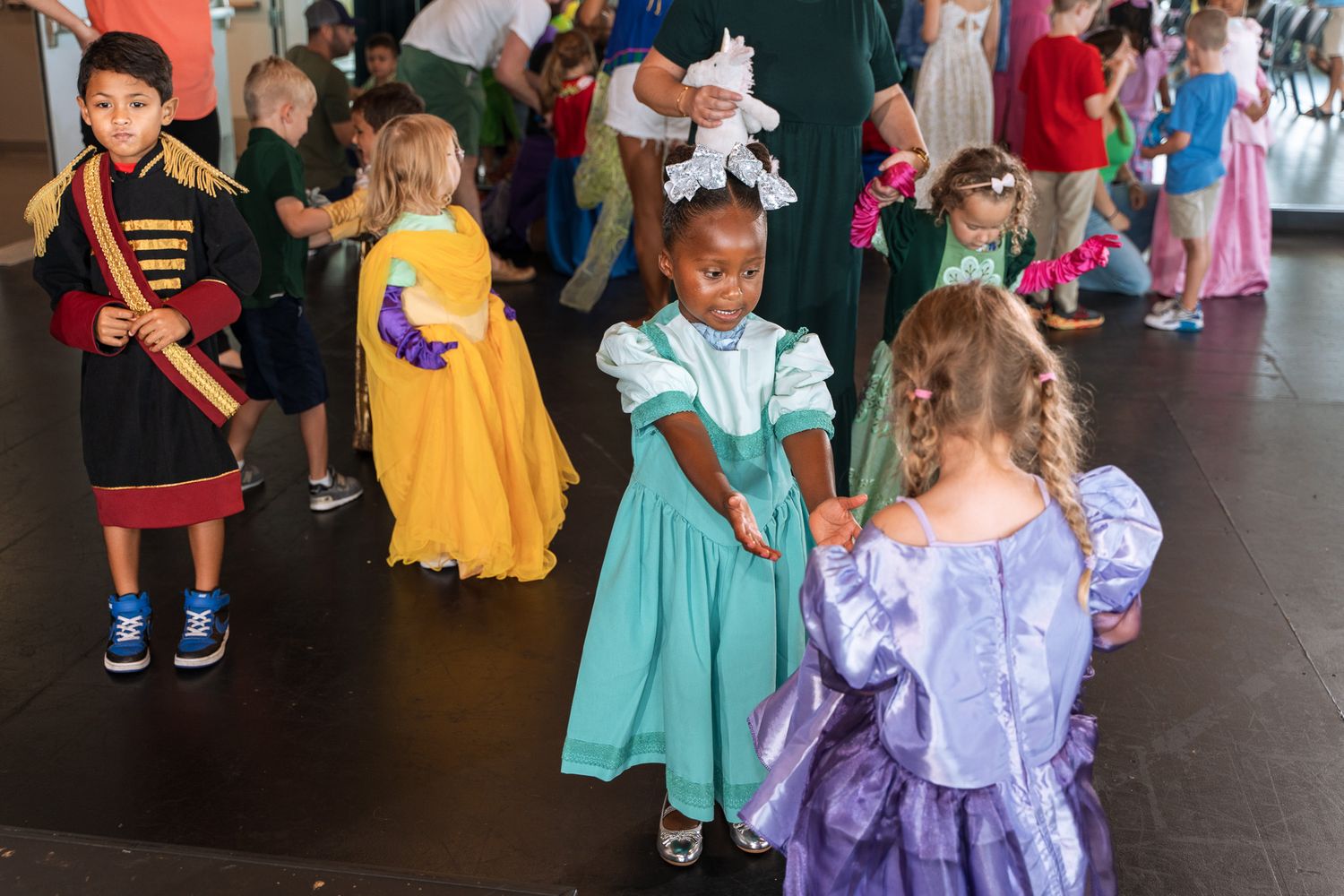 Kids dressed in princess and costume attire gather at a special event.