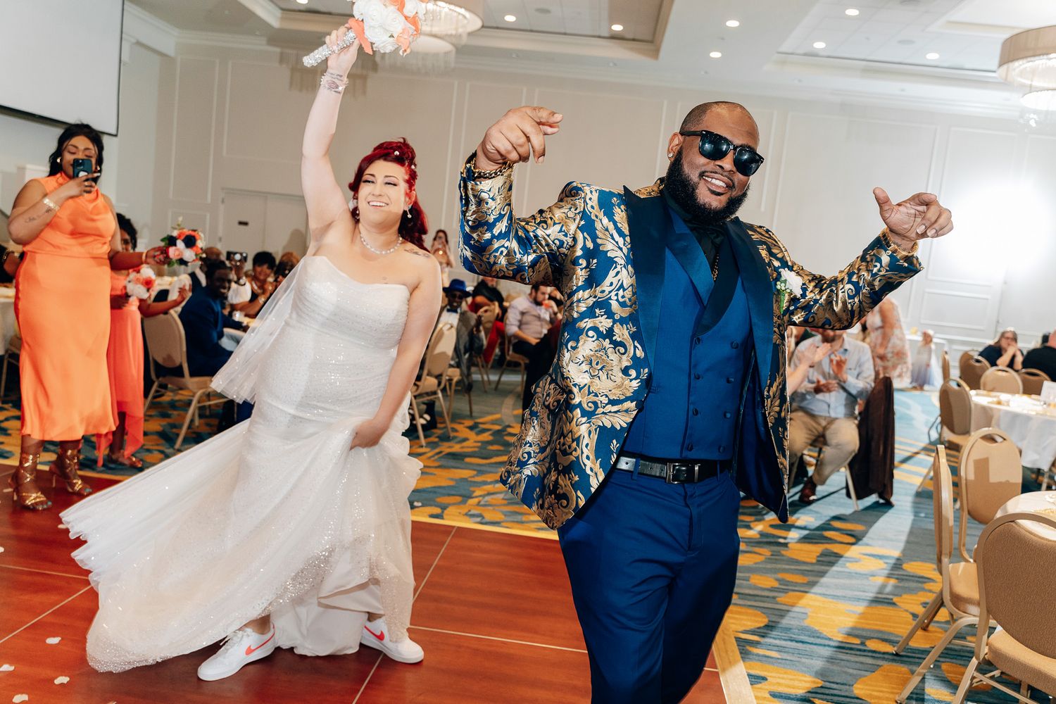 Newlyweds dancing energetically at their wedding reception.