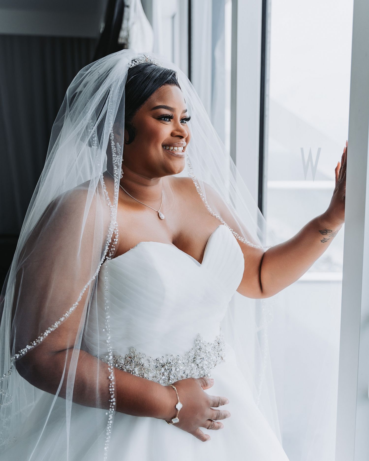 Beautiful wedding dress portrait showing intricate beading and sweetheart neckline with flowing veil.