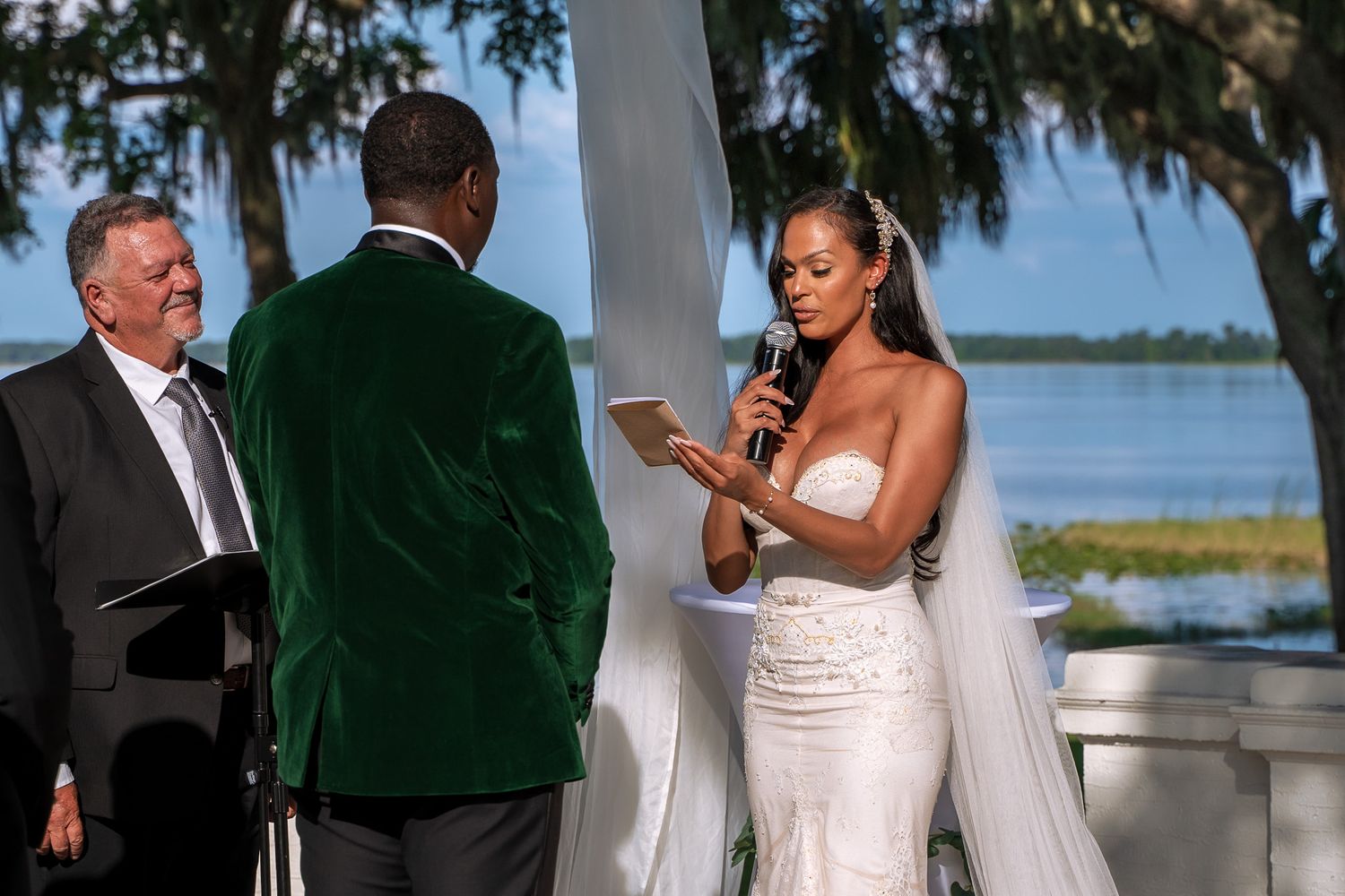 A couple exchanges vows during their waterfront wedding ceremony.