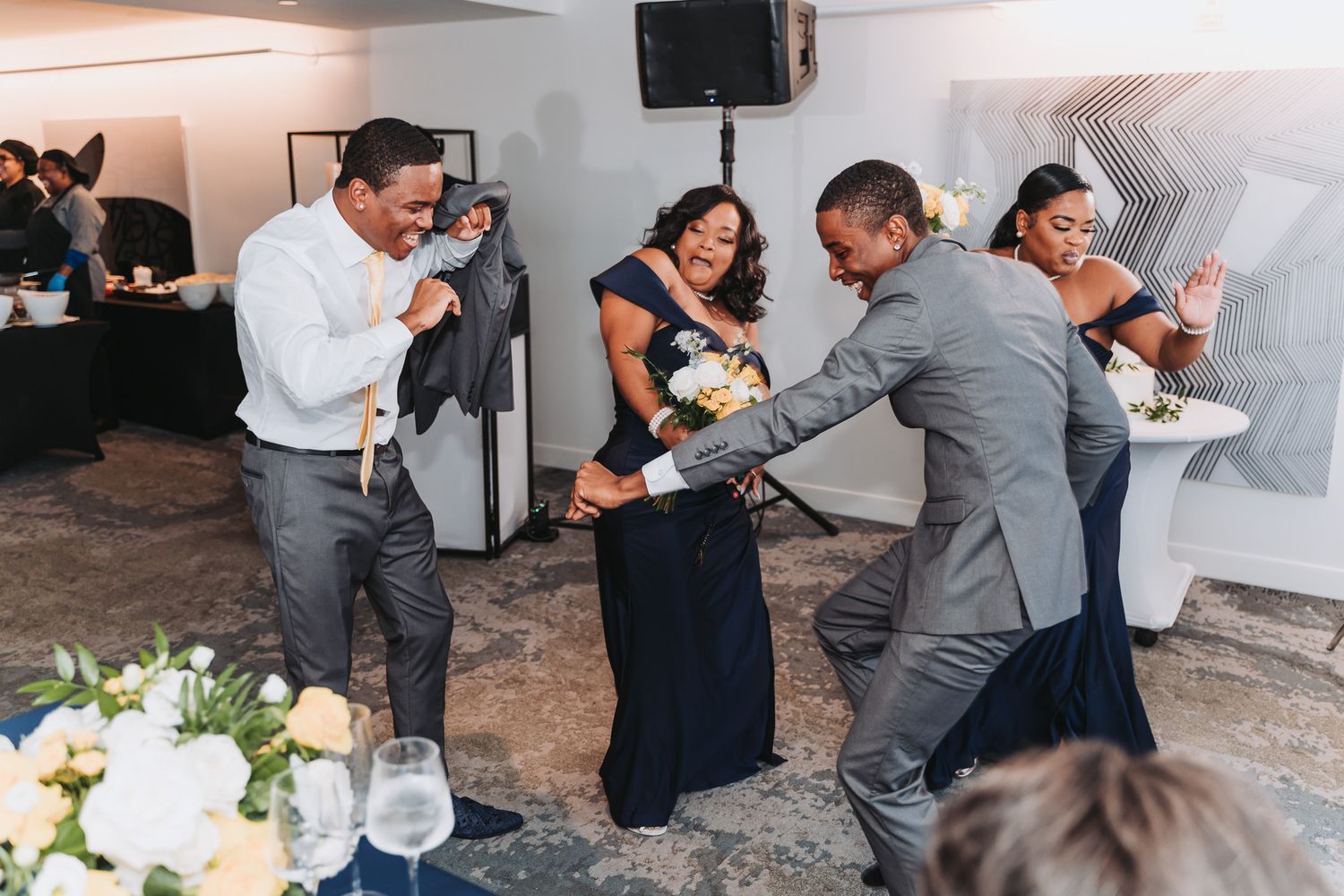 Wedding guests dancing and celebrating at reception party.