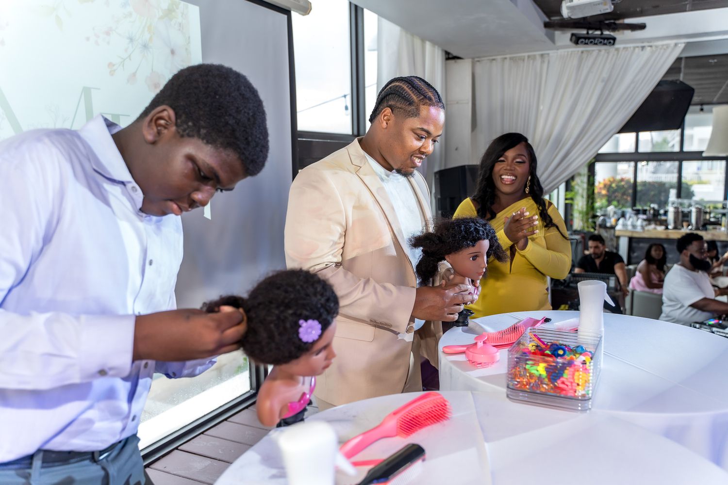 Party guests gathered around a table during a festive baby shower celebration.