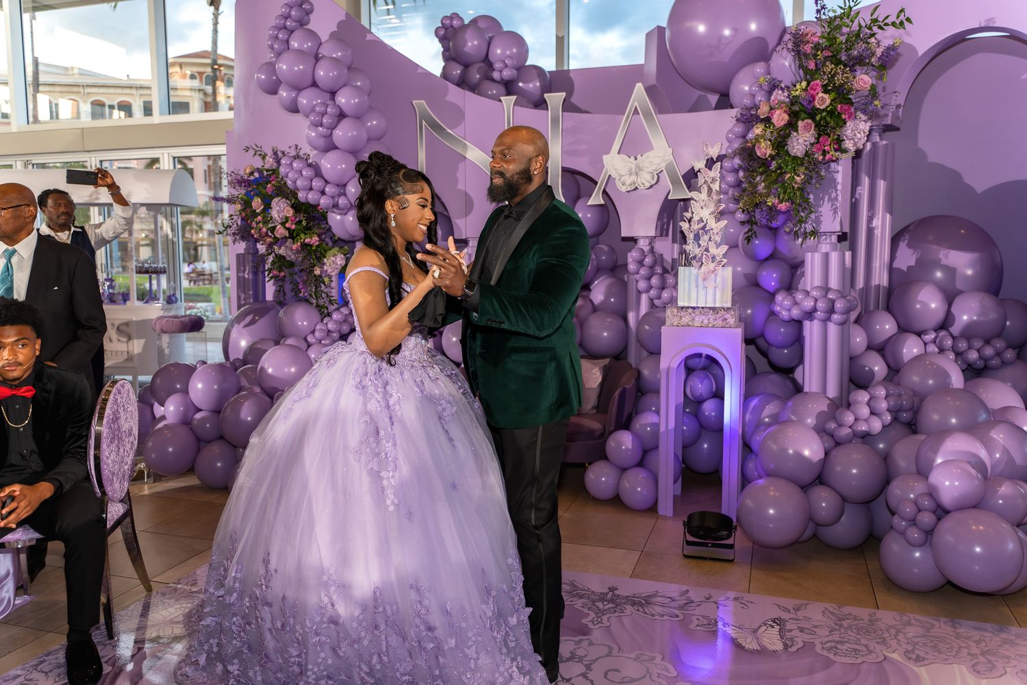 A special moment shared between two people during a formal celebration with purple decor.