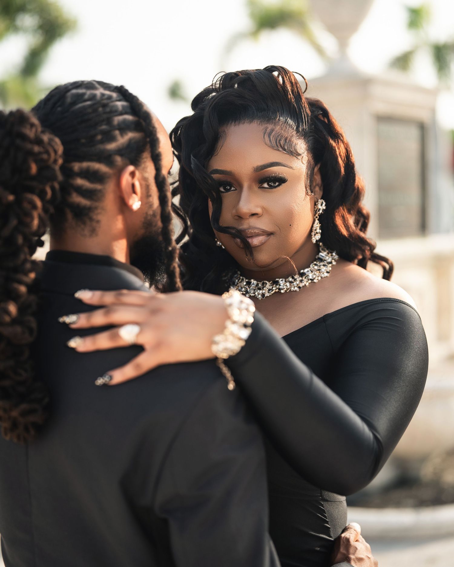 Artistic series of close-up photos showing intimate moments in black formal attire with a sparkly choker necklace.