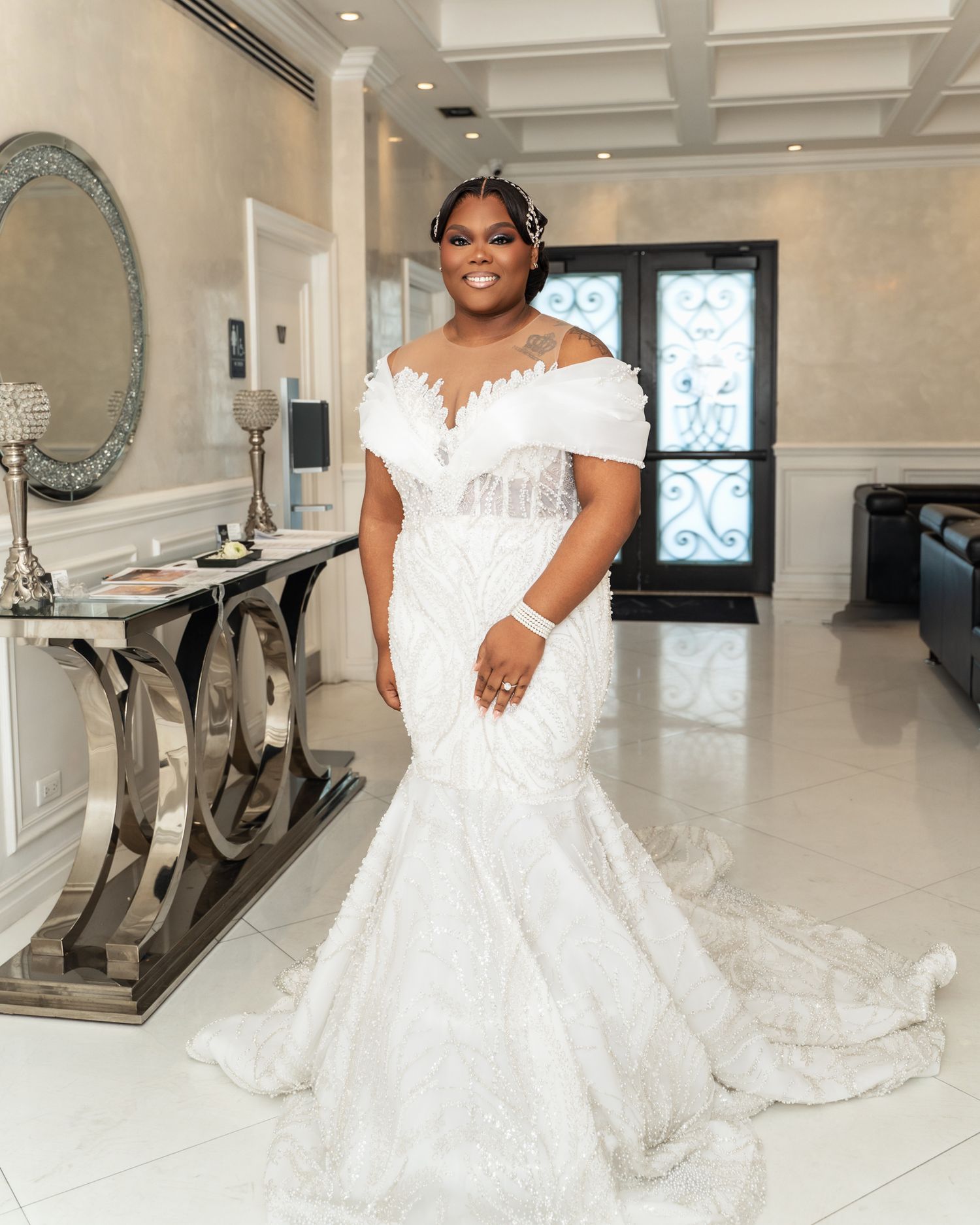Elegant bridal portraits in a luxurious white room with modern chrome furniture and coffered ceiling.