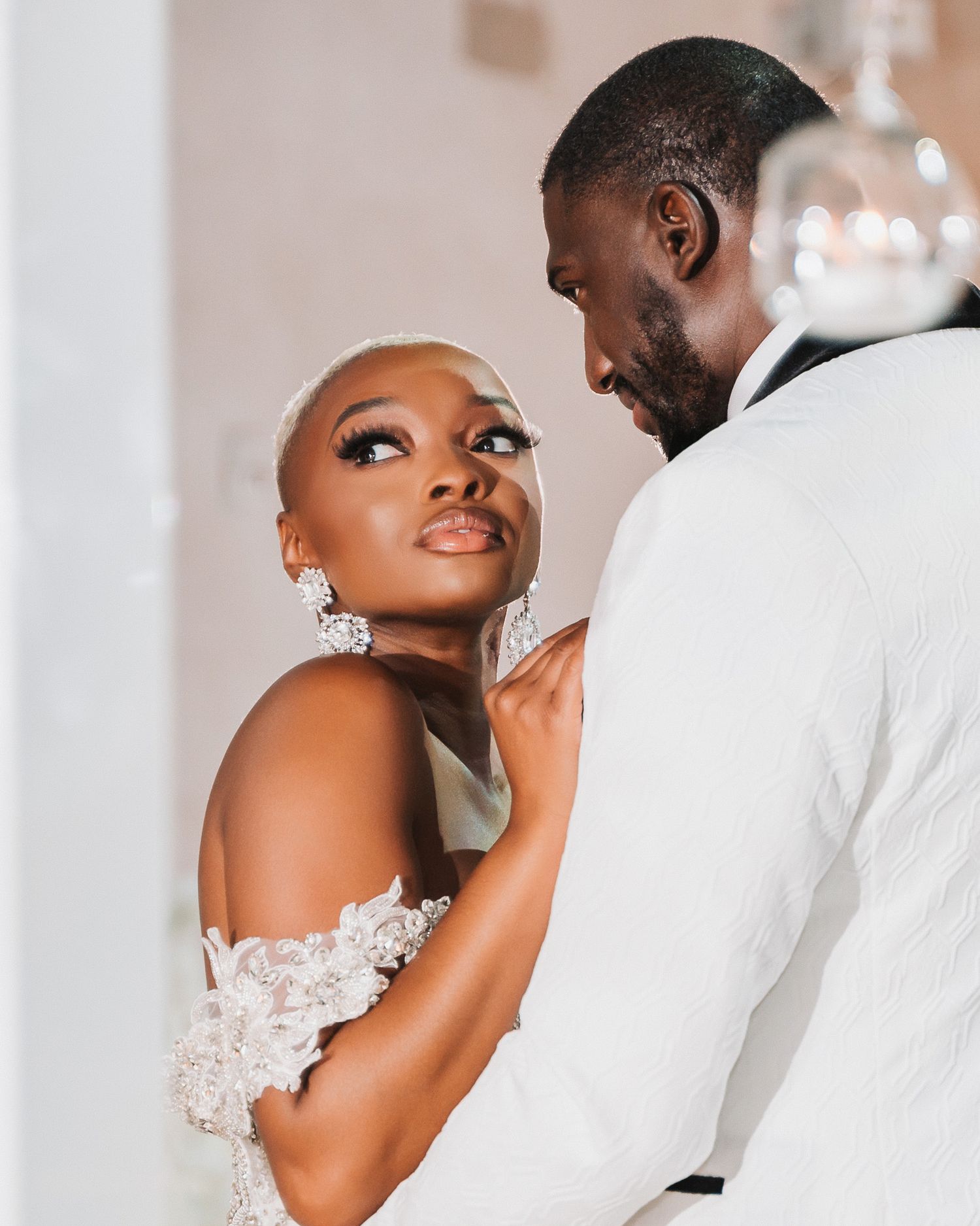 A close-up shot of a couple sharing an intimate moment in formal wedding attire.