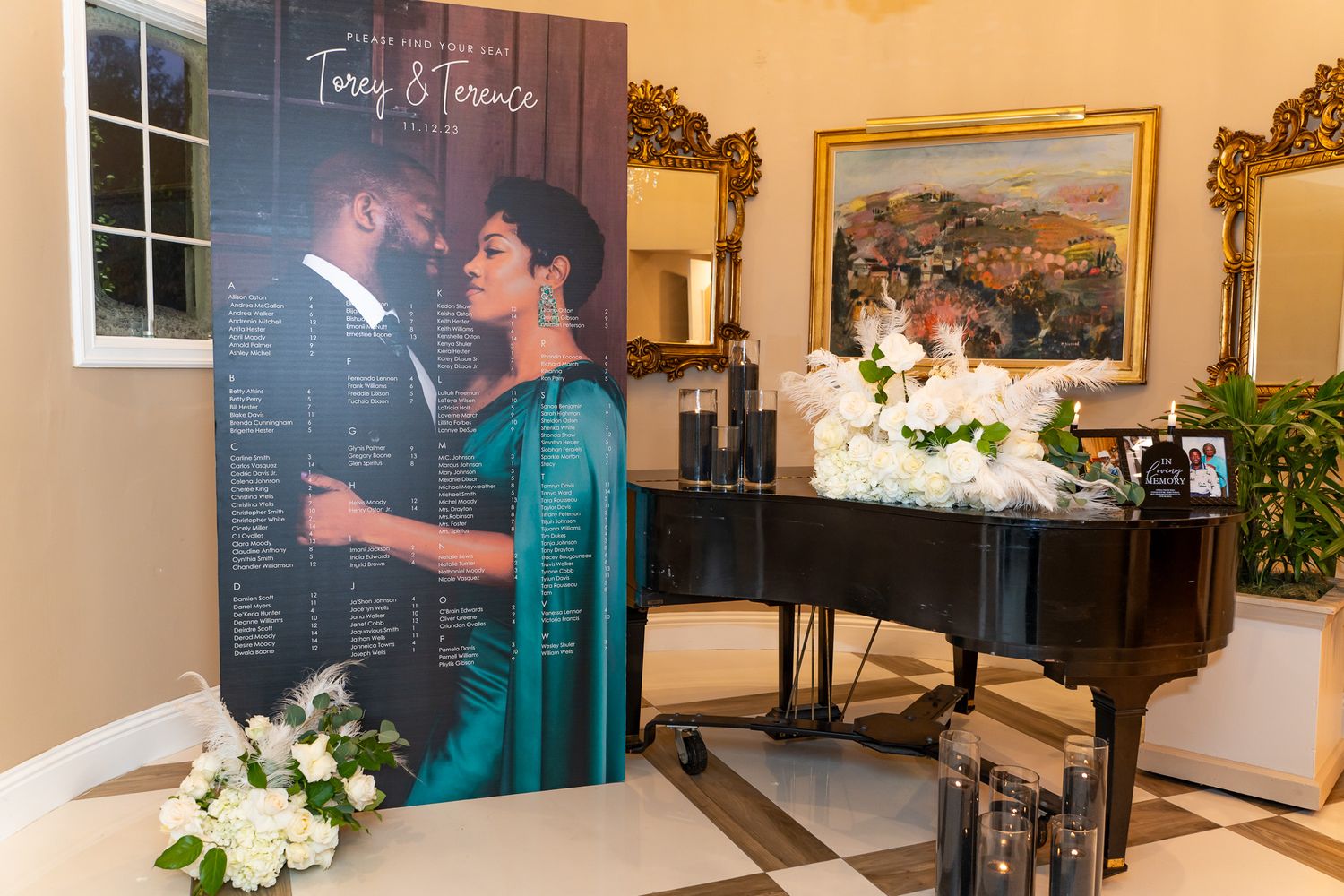 A display area with a grand piano, decorative artwork, and a large photo display in an elegant event space.