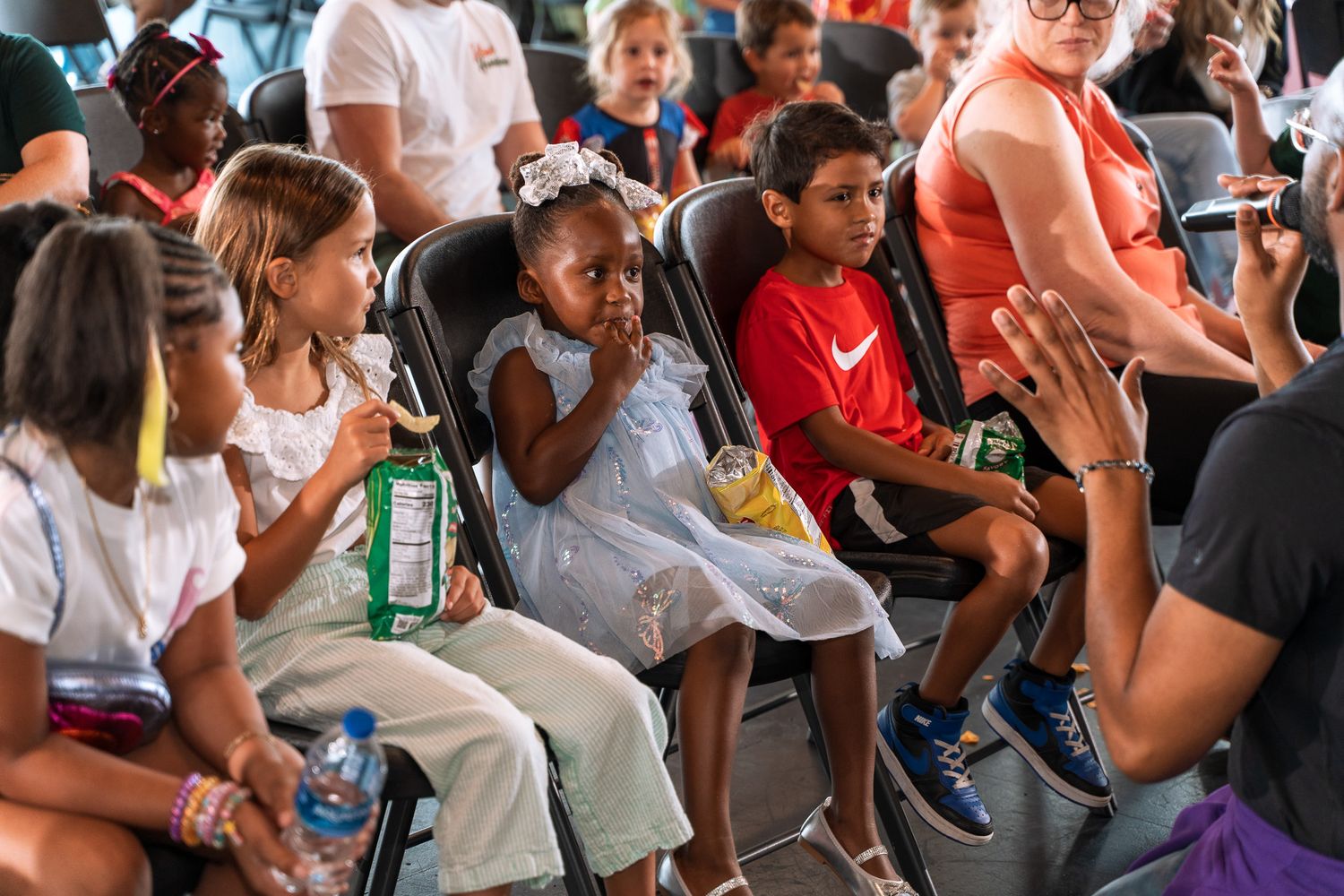 Audience members seated and engaged during an indoor event.