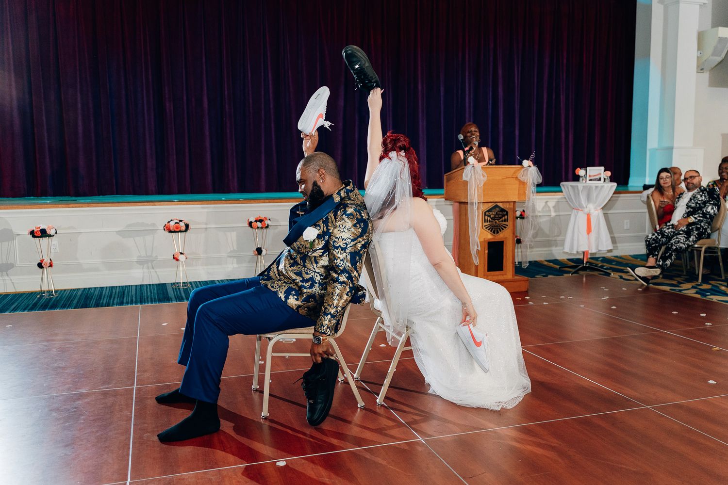 Wedding couple participates in fun reception game with chairs.