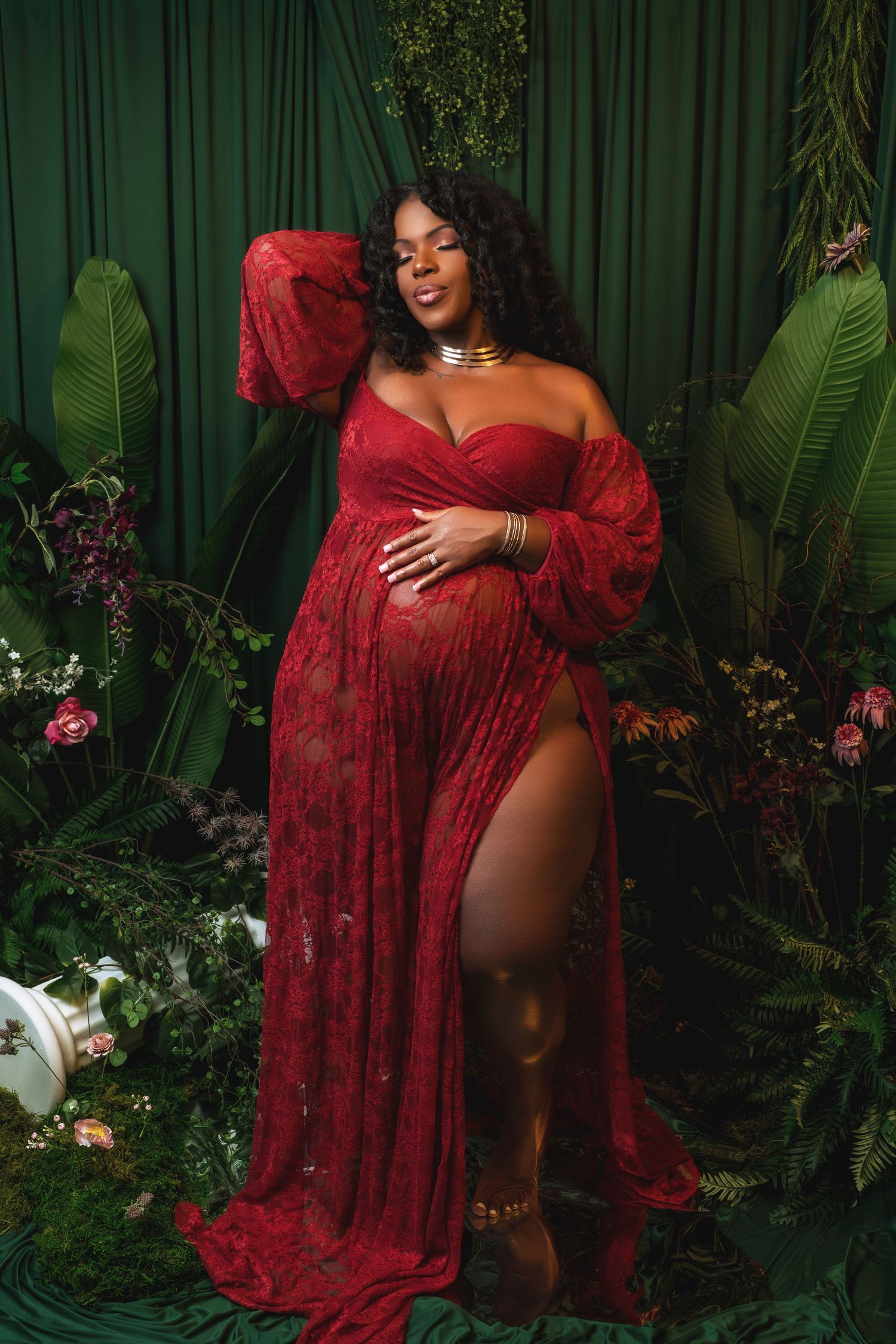 A series of four photos showing someone in a flowing red lace dress posing against a tropical garden backdrop.