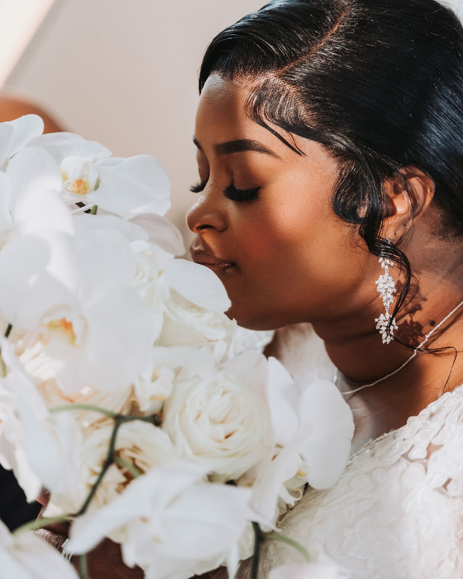 Close-up portrait with white orchids and roses bouquet.