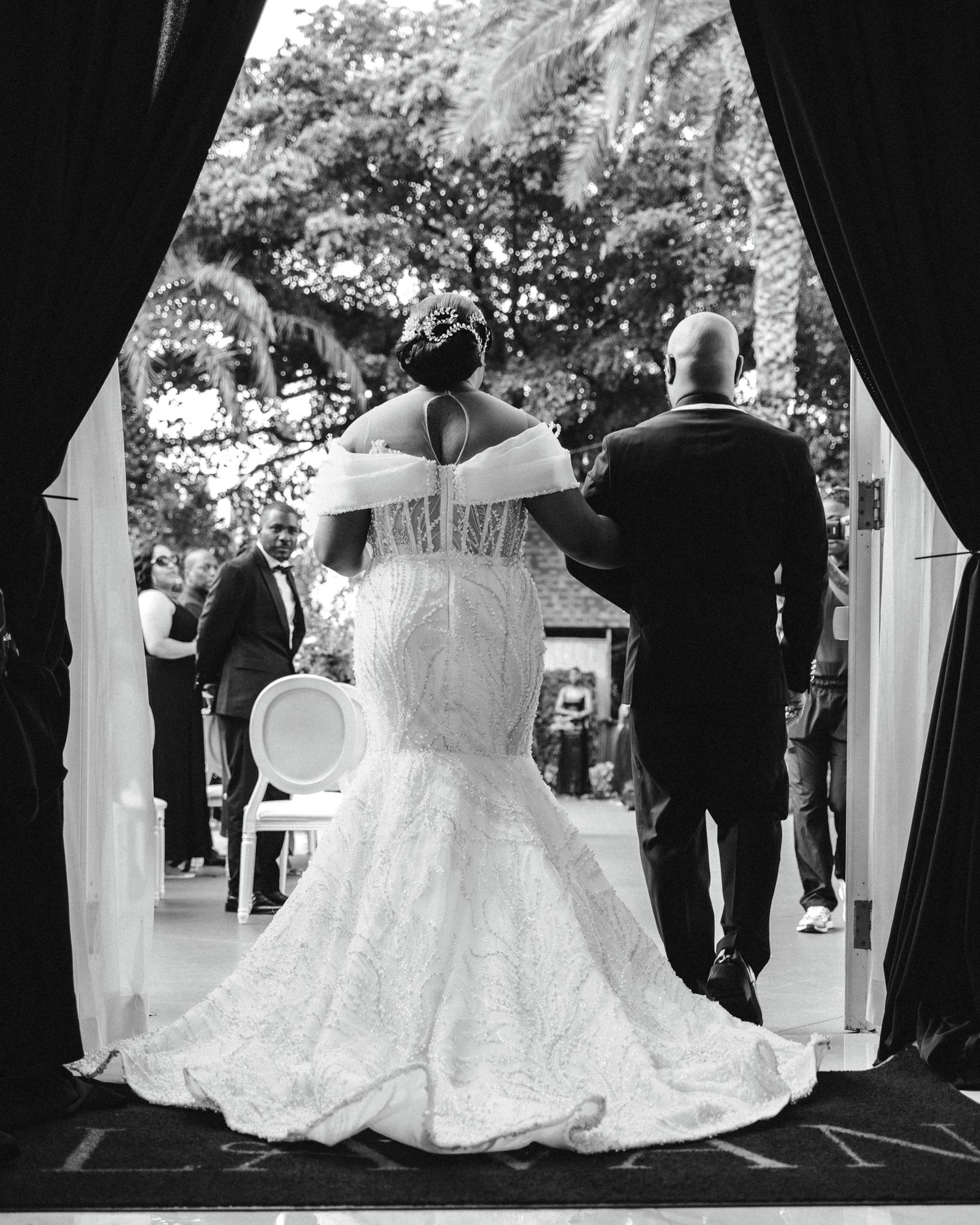 Black and white wedding ceremony photos showing flowing white bridal gowns in silhouette.