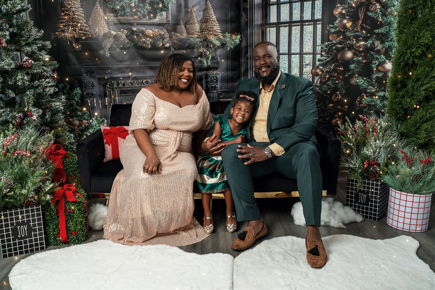 A family holiday portrait featuring elegant formal wear and festive Christmas decorations.