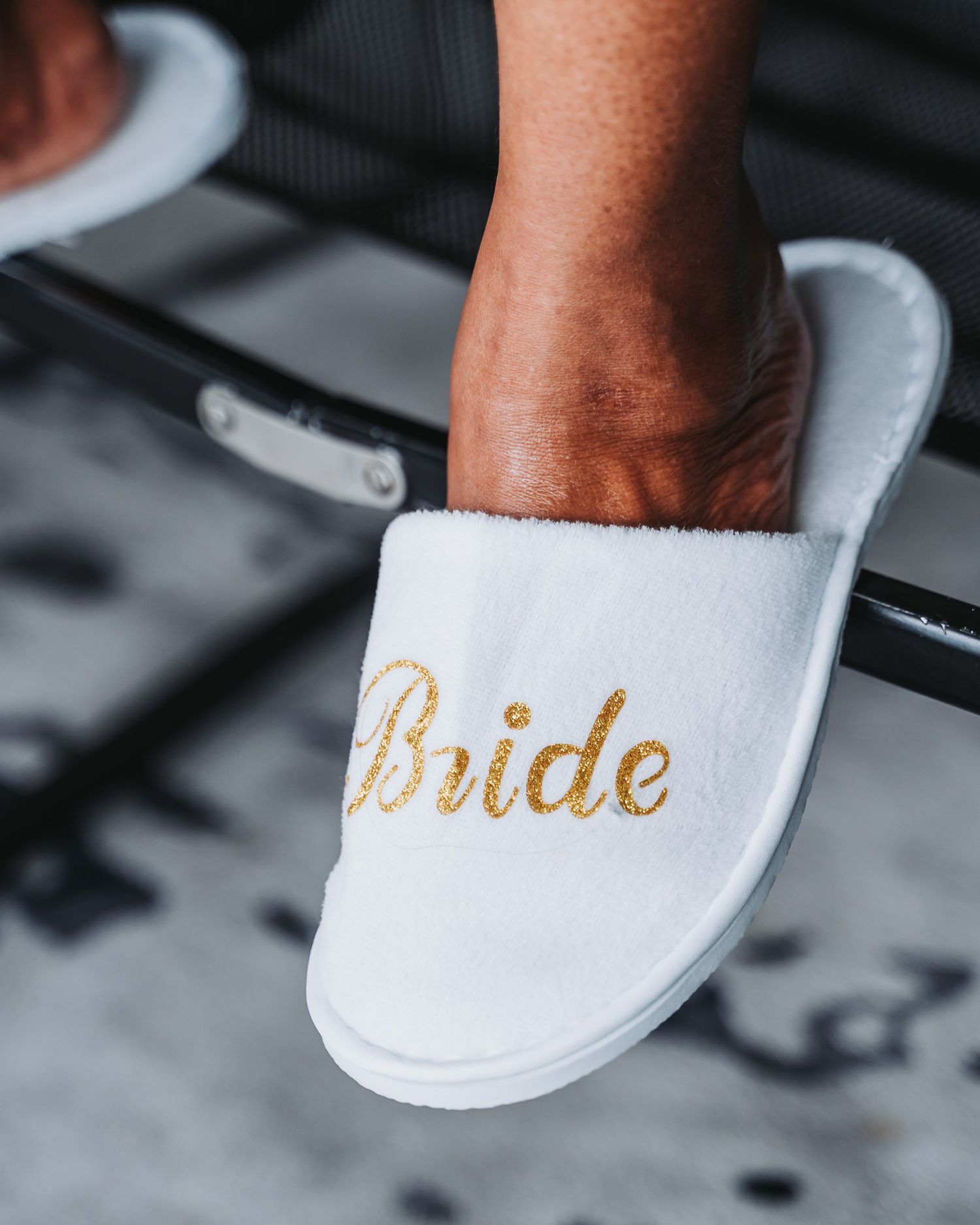 White spa slipper with gold 'Bride' text embroidery on top.