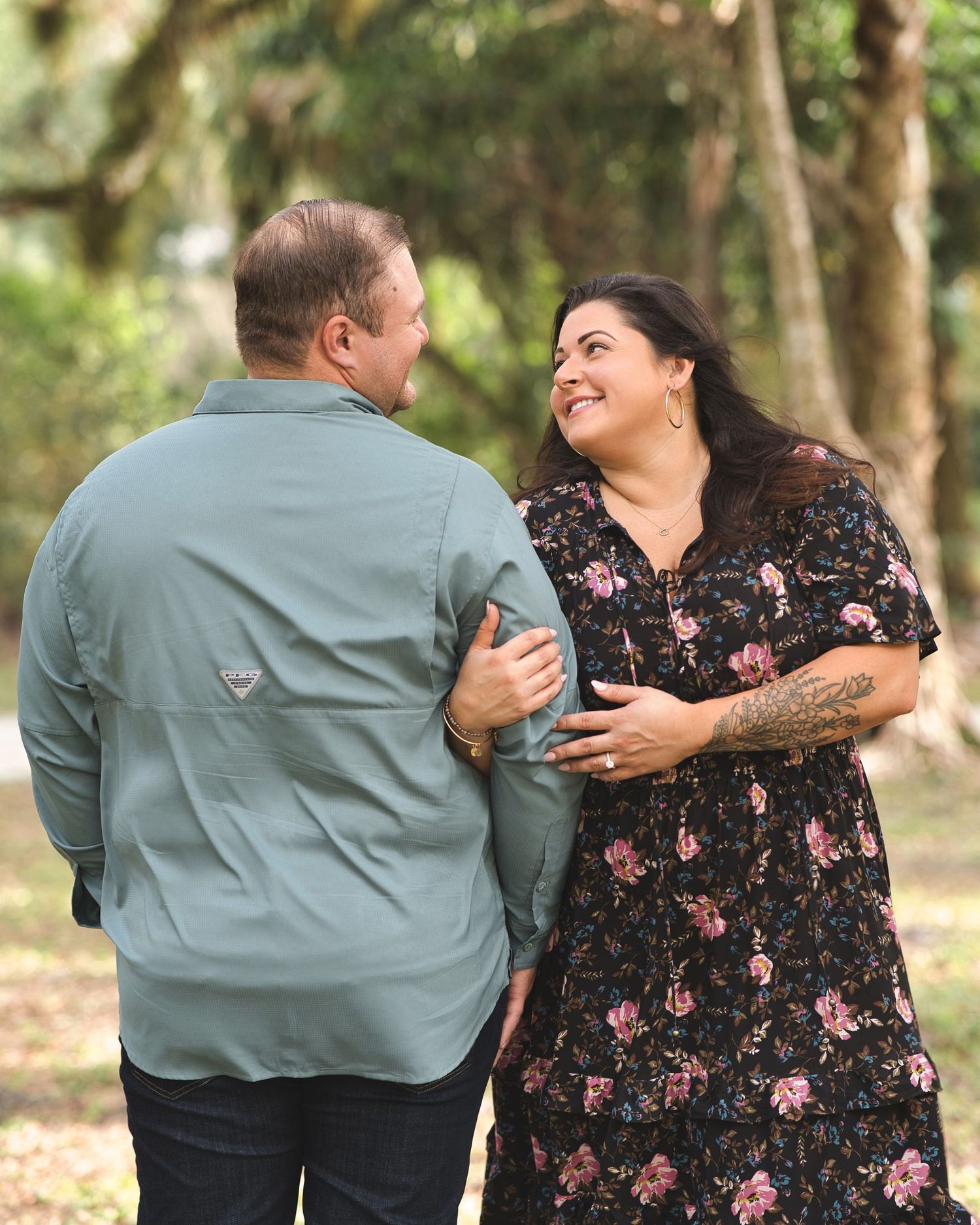 Couple sharing a joyful moment together in a scenic outdoor setting.