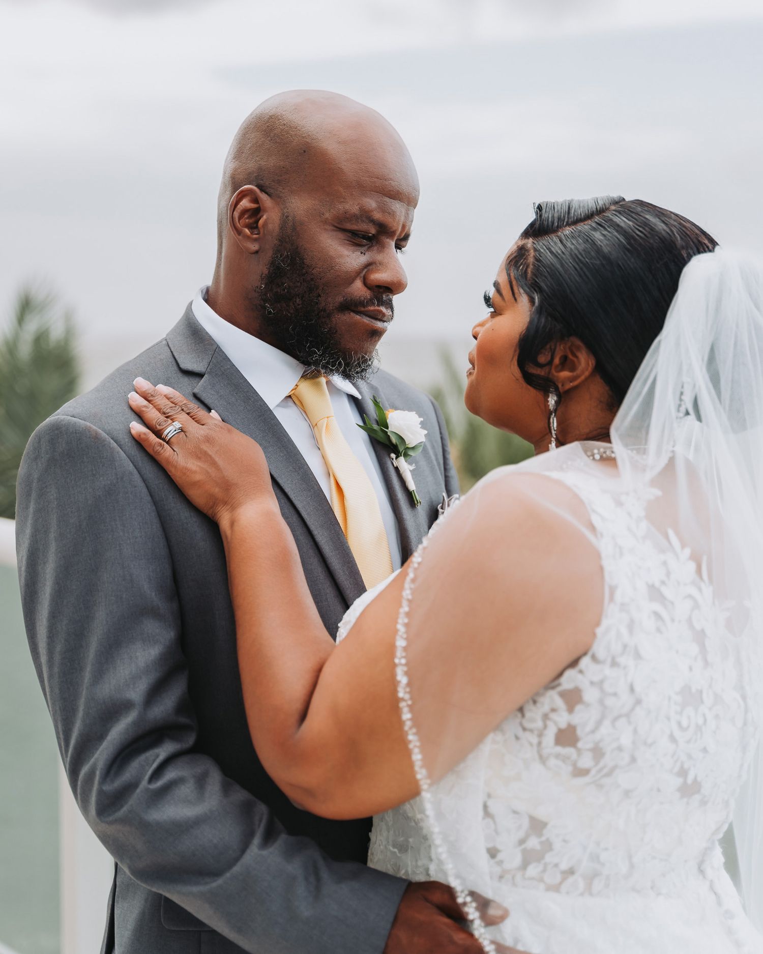 Intimate moment between couple during outdoor wedding photoshoot.